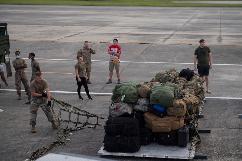 U.S. Air Force Master Sgt. Harry Dunmire, 23rd Logistics Readiness Squadron air terminal function section chief, inspects cargo netting prior to loading pallets at Moody Air Force Base, Georgia, Aug. 28, 2021. The 71st Rescue Squadron provided HC-130J Combat King II cargo aircraft to transport seven pallets and more than 160 Airmen from the 822nd Base Defense Squadron to Holloman Air Force Base, New Mexico, in support of Task Force – Holloman. The Department of Defense, through U.S. Northern Command, and in support of the Department of Homeland Security, is providing transportation, temporary housing, medical screening, and general support for at least 50,000 Afghan evacuees at suitable facilities, in permanent or temporary structures, as quickly as possible. This initiative provides Afghan personnel essential support at secure locations outside Afghanistan. (U.S. Air Force photo by Master Sgt. Daryl Knee)