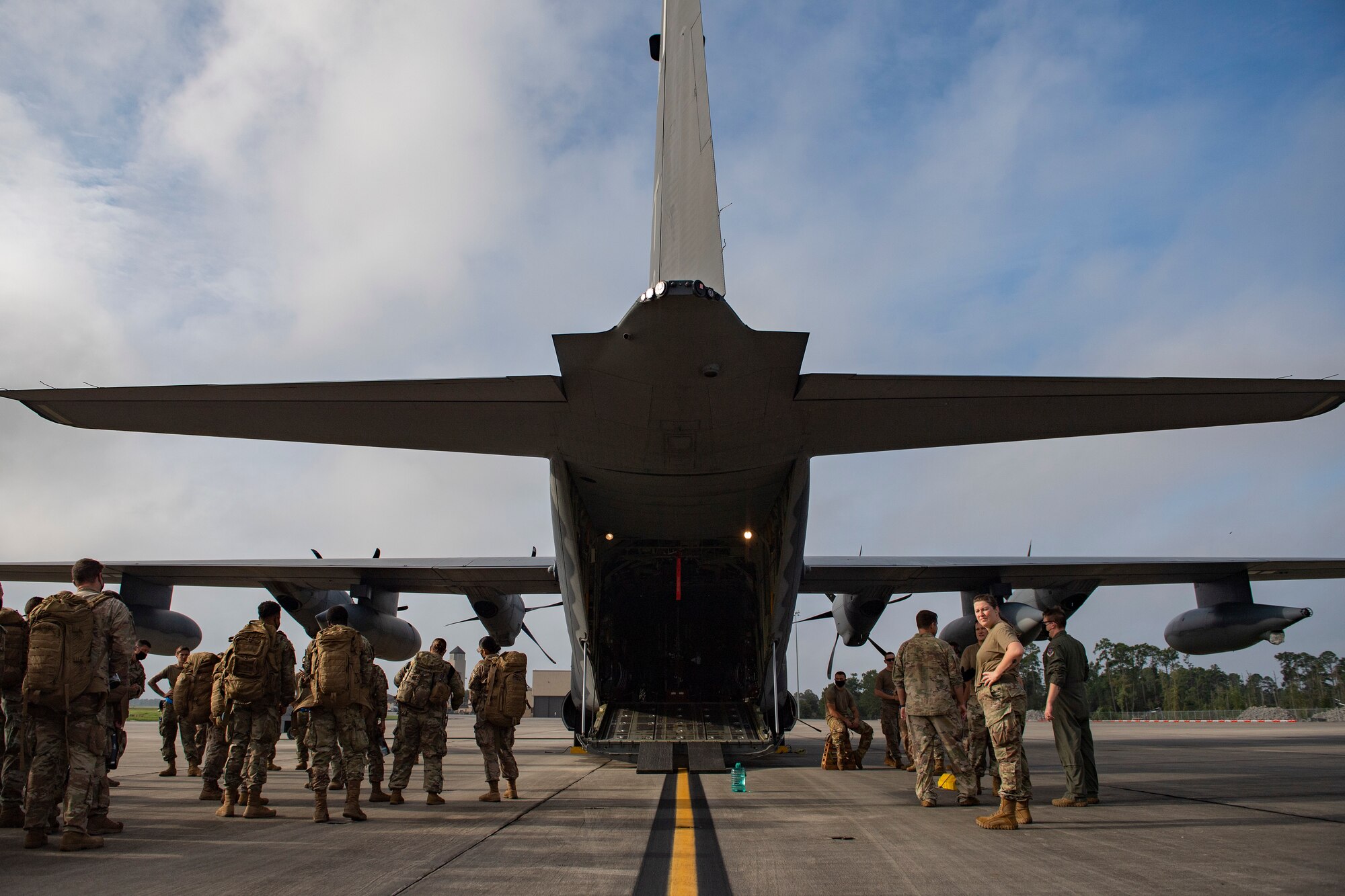 U.S. Air Force Airmen from the 822nd Base Defense Squadron prepare to load onto an HC-130J Combat King II cargo aircraft from the 71st Rescue Squadron at Moody Air Force Base, Georgia, Aug. 28, 2021. The 23rd Wing and the 93rd Air Ground Operations Wing partnered together to ensure the 822nd BDS Airmen could arrive at Holloman Air Force Base, New Mexico, in support of Task Force – Holloman. The Department of Defense, through U.S. Northern Command, and in support of the Department of Homeland Security, is providing transportation, temporary housing, medical screening, and general support for at least 50,000 Afghan evacuees at suitable facilities, in permanent or temporary structures, as quickly as possible. This initiative provides Afghan personnel essential support at secure locations outside Afghanistan. (U.S. Air Force photo by Master Sgt. Daryl Knee)