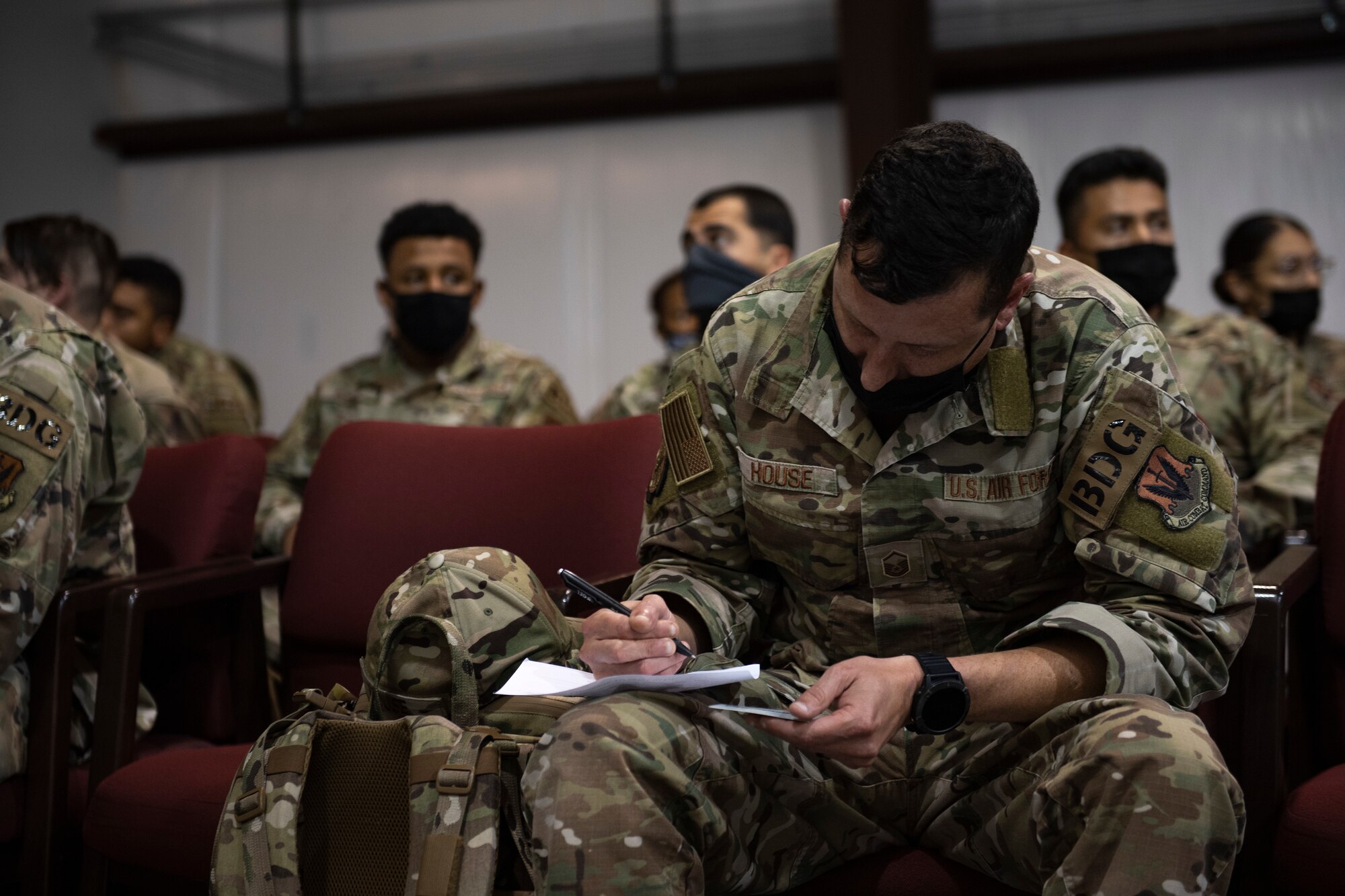 U.S. Air Force Master Sgt. Mitchell House, an 822nd Base Defense Squadron member deployed to Holloman Air Force Base, New Mexico, fills out his in-processing paperwork Aug. 28, 2021. All military members arriving are in support of Task Force – Holloman. The Department of Defense, through U.S. Northern Command, and in support of the Department of Homeland Security, is providing transportation, temporary housing, medical screening, and general support for at least 50,000 Afghan evacuees at suitable facilities, in permanent or temporary structures, as quickly as possible. This initiative provides Afghan personnel essential support at secure locations outside Afghanistan. (U.S. Air Force photo by Master Sgt. Daryl Knee)