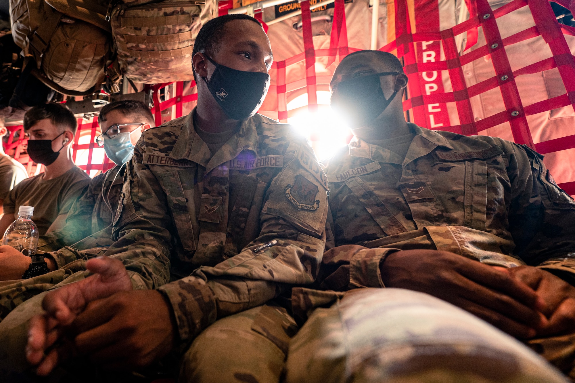 U.S. Air Force Airmen assigned to the 822nd Base Defense Squadron converse as they wait to depart on an HC-130J Combat King II aircraft at Moody Air Force Base, Georgia, Aug. 29, 2021. The 822nd BDS was tasked to provide an enhanced security presence at Holloman Air Force Base, New Mexico, in support of Task Force – Holloman. The Department of Defense, through U.S. Northern Command, and in support of the Department of Homeland Security, is providing transportation, temporary housing, medical screening, and general support for at least 50,000 Afghan evacuees at suitable facilities, in permanent or temporary structures, as quickly as possible. This initiative provides Afghan personnel essential support at secure locations outside Afghanistan. (U.S. Air Force photo by Staff Sgt. Devin Boyer)