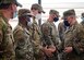 Photo of U.S. Army Gen. Mark Milley, right, the 20th Chairman of the Joint Chiefs of Staff, coining Airmen at Joint Base McGuire-Dix-Lakehurst.