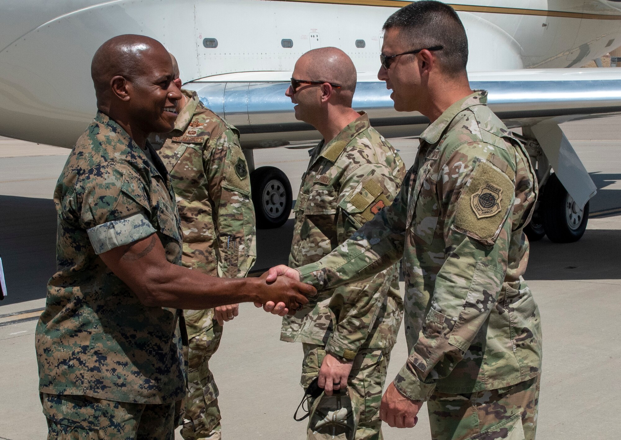 Sgt. Maj. James Porterfield, left, Command Senior Enlisted Leader, North American Aerospace Defense Command and U.S. Northern Command, greets Chief Master Sgt. Eric West, Task Force - Holloman command chief, upon arrival at Holloman Air Force Base, New Mexico, Sept. 7, 2021.  The senior enlisted leaders joined with Gen. Glen VanHerck, Commander, NORAD and USNORTHCOM; Mr. Terry Todd, Department of Homeland Security's Federal Coordinator at Holloman AFB; Mr. Joe Parente, Department of State Team Lead; Rep. Melanie Stansbury (D-NM-1) and Rep. Yvette Herrell (R-NM-2), touring housing facilities and other support functions for the Afghan evacuees on the installation. (U.S. Air Force photo by Staff Sgt. Kenneth Boyton)