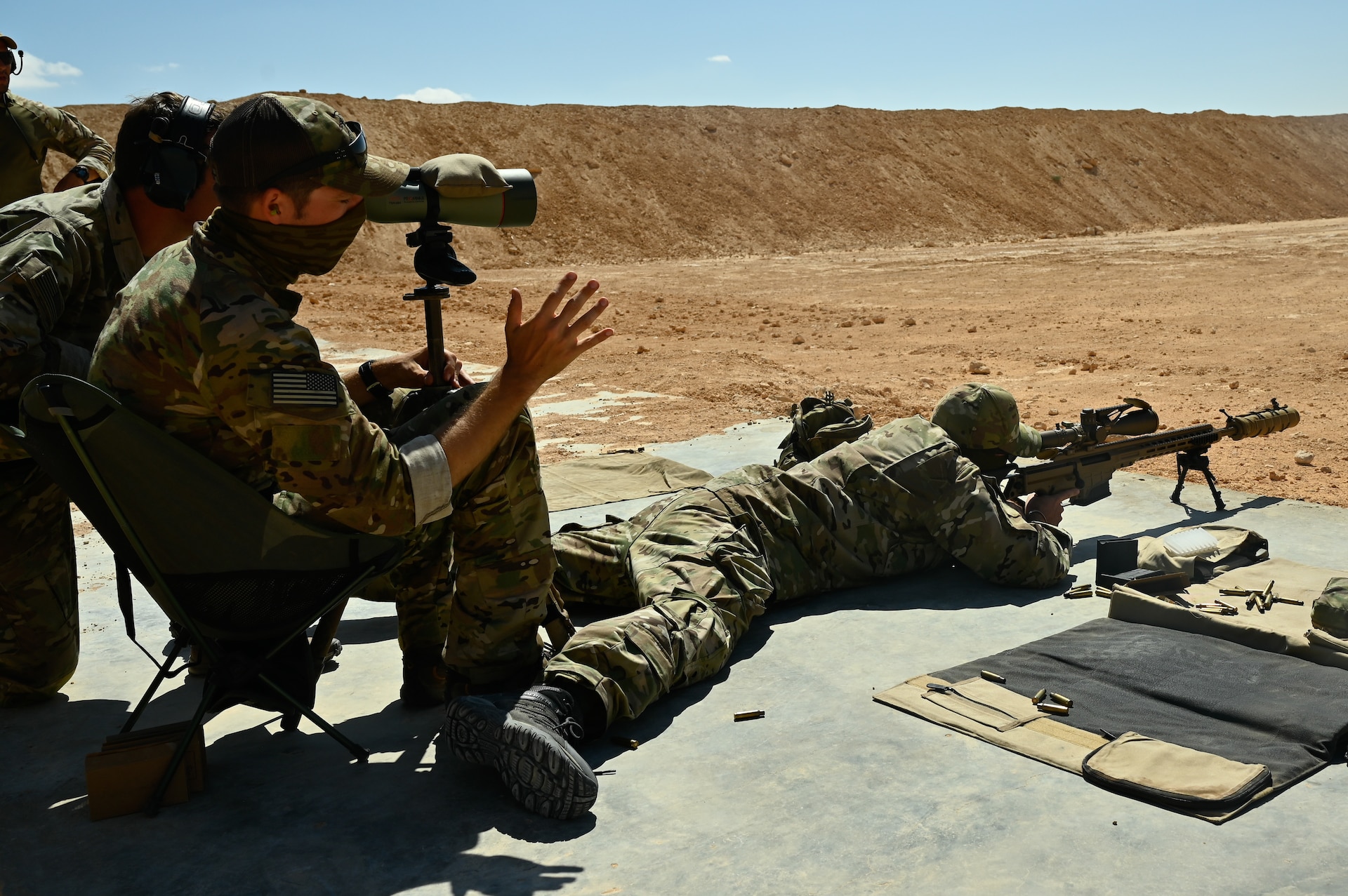 A U.S. green beret gives guidance on firing techniques to a partner nation special operator at a sniper range during Bright Star 21 (BS21) at Mohamed Naguib Military Base (MNMB), Egypt, Sept. 5, 2021. BS21 increases interoperability for future threat response in conventional and irregular warfare. (U.S. Army photo by Spc. Amber Cobena)