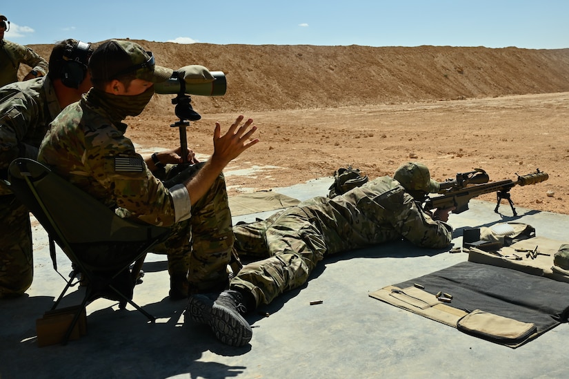 A U.S. green beret gives guidance on firing techniques to a partner nation special operator at a sniper range during Bright Star 21 (BS21) at Mohamed Naguib Military Base (MNMB), Egypt, Sept. 5, 2021. BS21 increases interoperability for future threat response in conventional and irregular warfare. (U.S. Army photo by Spc. Amber Cobena)