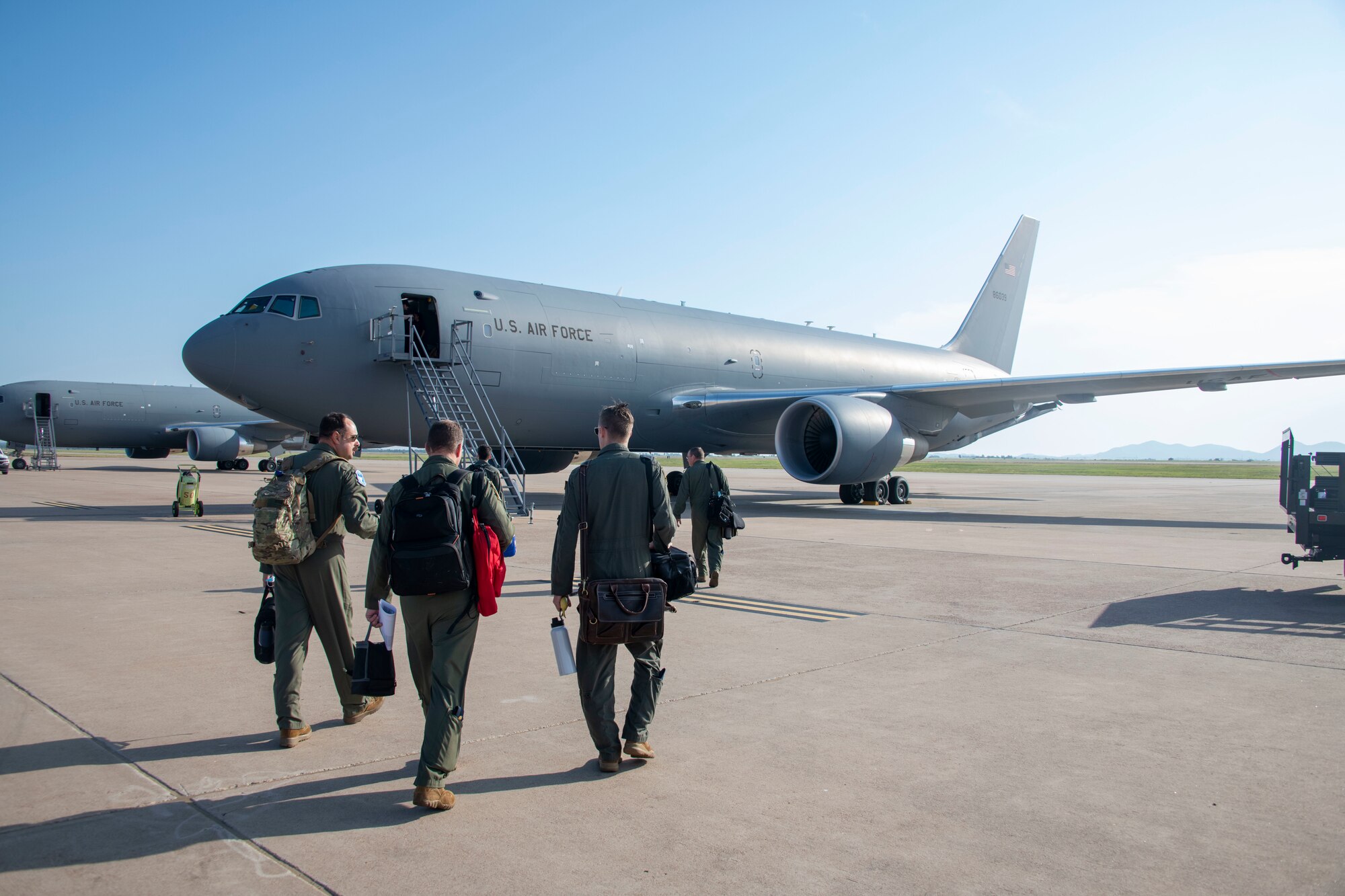 people walk toward aircraft