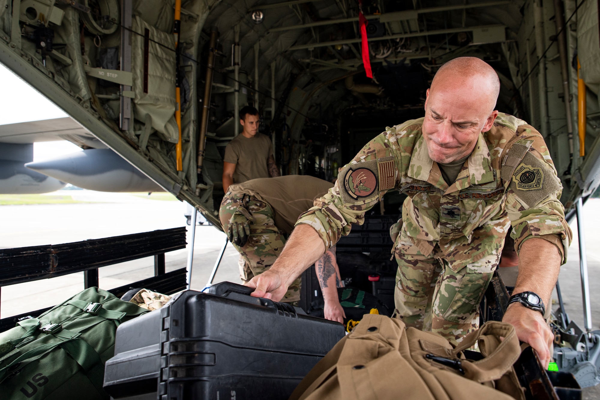 Photo of Airmen loading an aircraft