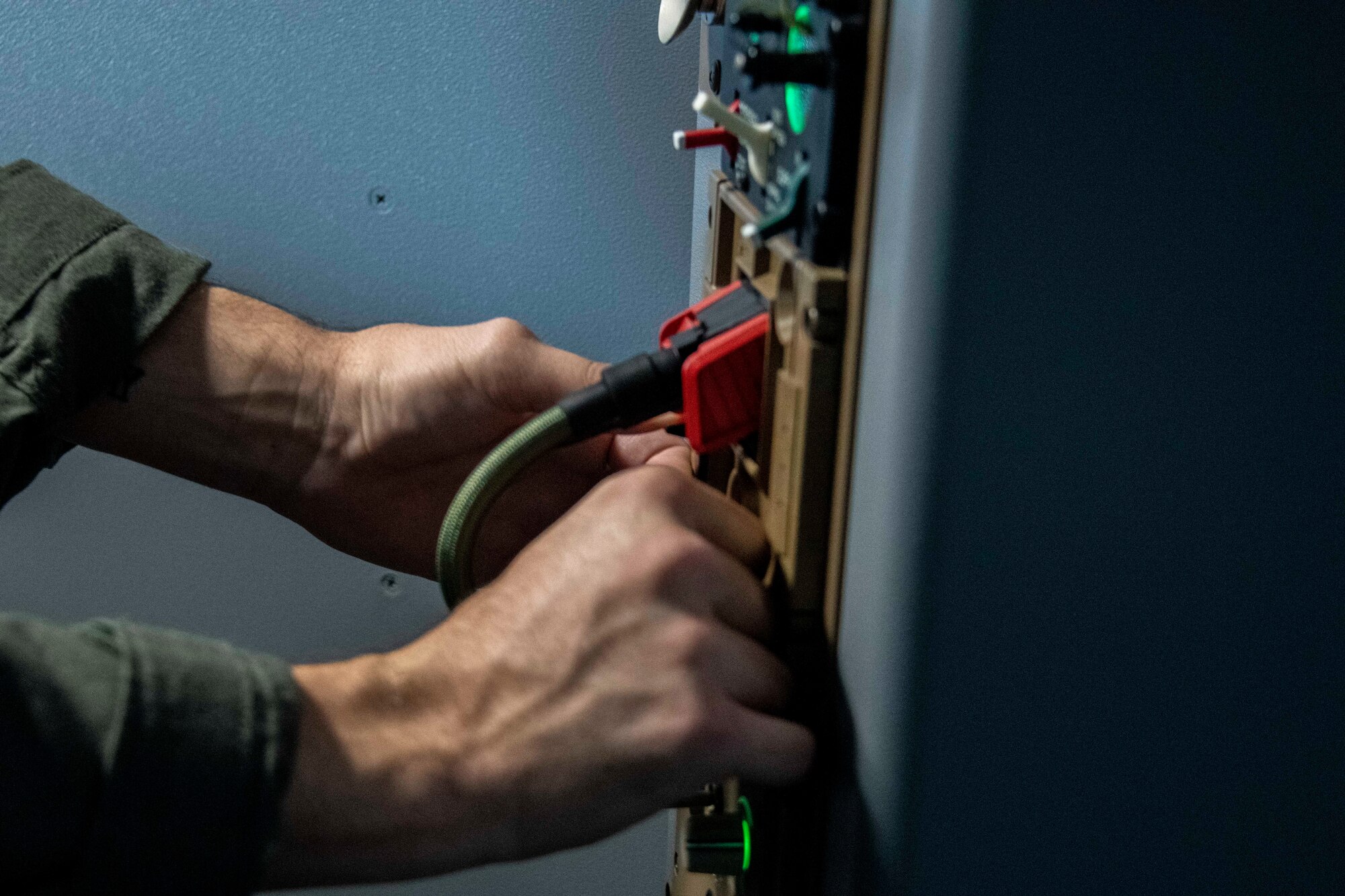 person inspects dials and knobs