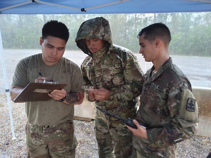 Sgt. Joemicheal Cristobal, Spc. Osias Passi, and Spc. Brennon Westfall, members of the Alaska Army National Guard and Task Force-Alaska, log trailer and driver information on a yard dog sheet, at a transportation yard in Roseland, Louisiana, Sept. 7, 2021. 17 Alaska Guardsmen are assisting the Louisiana National Guard's support to civil authorities in the aftermath of Hurricane Ida, which struck the state Aug. 29, leaving disaster, destruction and flooding in its wake. (U.S. Army National Guard photo by Staff Sgt. Jacob Tyrrell)