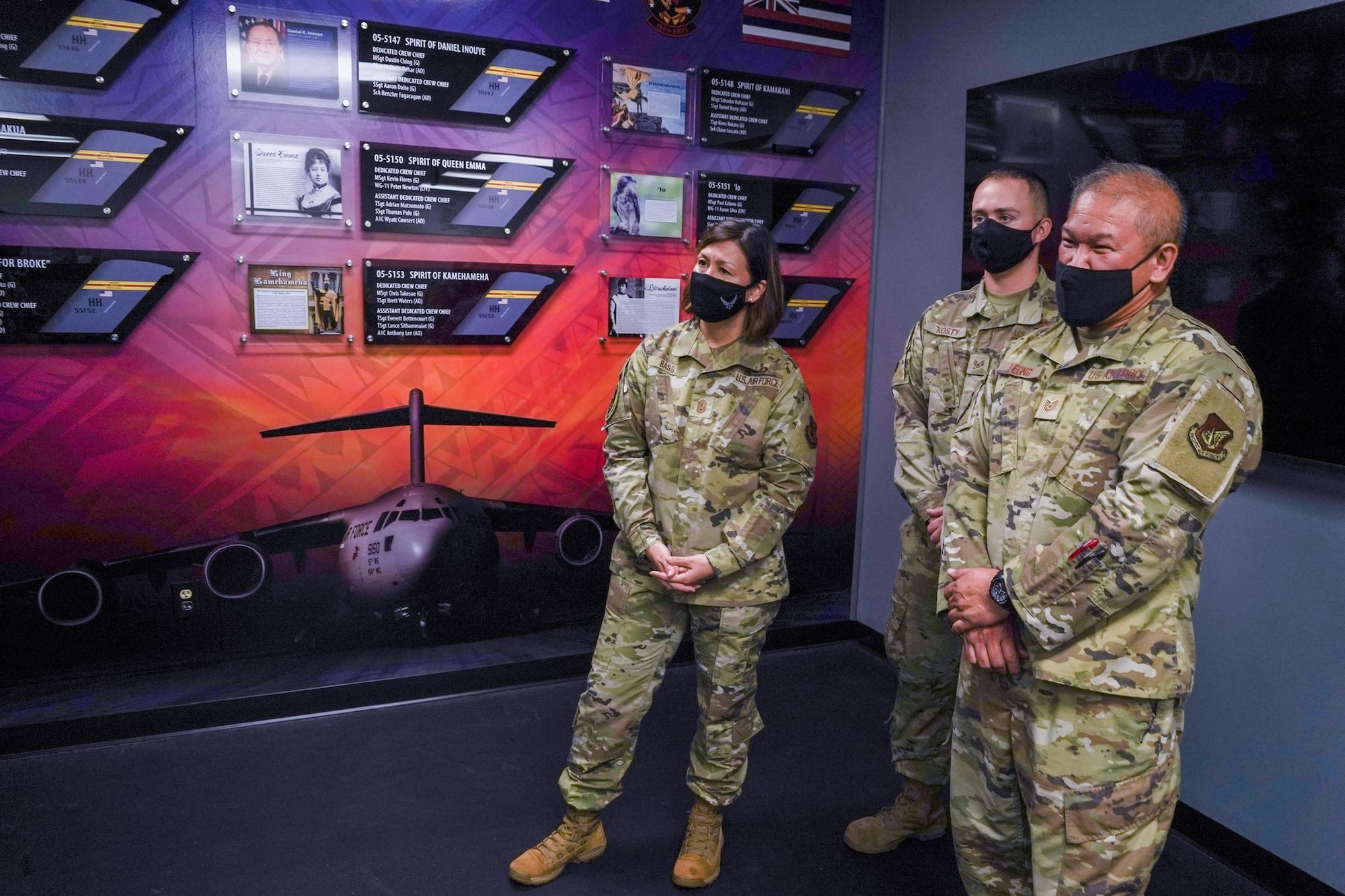 Chief Master Sergeant of the Air Force JoAnne S. Bass visits with Tech. Sgt. Samuel Leong, 154th Aircraft Maintenance Squadron crew chief, and Staff Sgt. Daniel Kosty, 15th Aircraft Maintenance Squadron aerospace maintenance apprentice, during a tour of the 15th Maintenance Group at Joint Base Pearl Harbor-Hickam, August 31, 2021. Leong and Kotsy introduced the newly designed legacy wall during Chief Bass’ visit to several squadrons around JBPHH to gain a  look into their unique mission and discuss priorities such as people, culture, and readiness. (U.S. Air Force photo by Airman 1st Class Makensie Cooper)