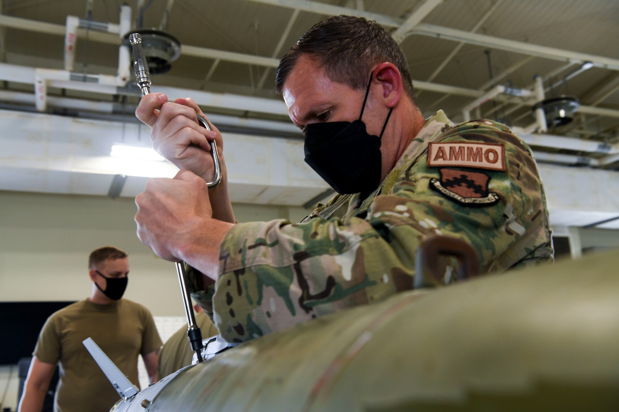 A commander works on a munition.
