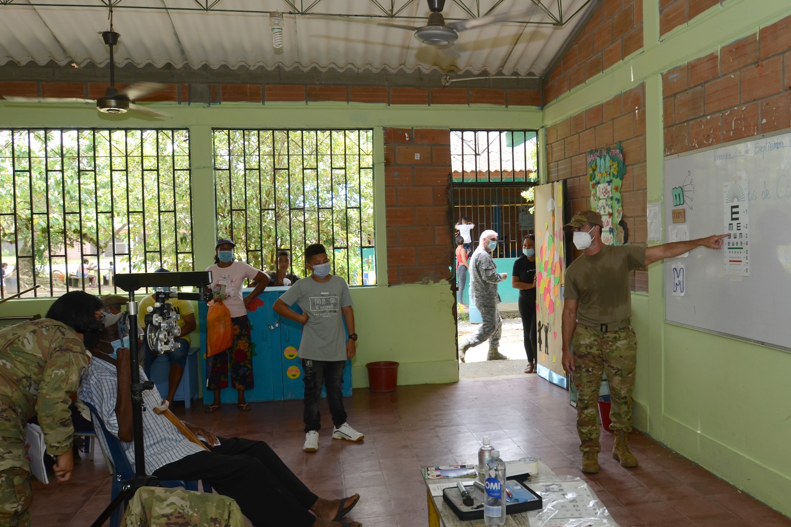 U.S. Air Force Maj. Sean Pitale (right), a doctor with the 169th Medical Group, and U.S. Army Specialist America Oropeza, a medic with the South Carolina Army National Guard, provide an optical exam to a Colombian patient September 4, 2021. Doctors and med techs from the South Carolina Air National Guard’s 169th Medical Group teamed up with medics from the South Carolina Army National Guard to travel to the remote town of Tamana, Colombia to participate in a real-word community medical and humanitarian support mission September 4, 2021. While there, the medical personnel provided dental, optical, dermatology, pharmacy and general medical care to more than 300 patients. South Carolina Air National Guard and South Carolina Army National Guard medical personnel participate in the regional Ángel de los Andes (Angel of the Andes) and Cooperación VII exercises in Colombia August 30 to September 10, 2021. The exercises provide training opportunities with South Carolina’s state partner Colombia in realistic combat search and rescue missions as well as humanitarian aid and disaster response scenarios such as earthquakes and tsunamis. (U.S. Air National Guard photo by Lt. Col. Jim St.Clair, 169th Fighter Wing Public Affairs)