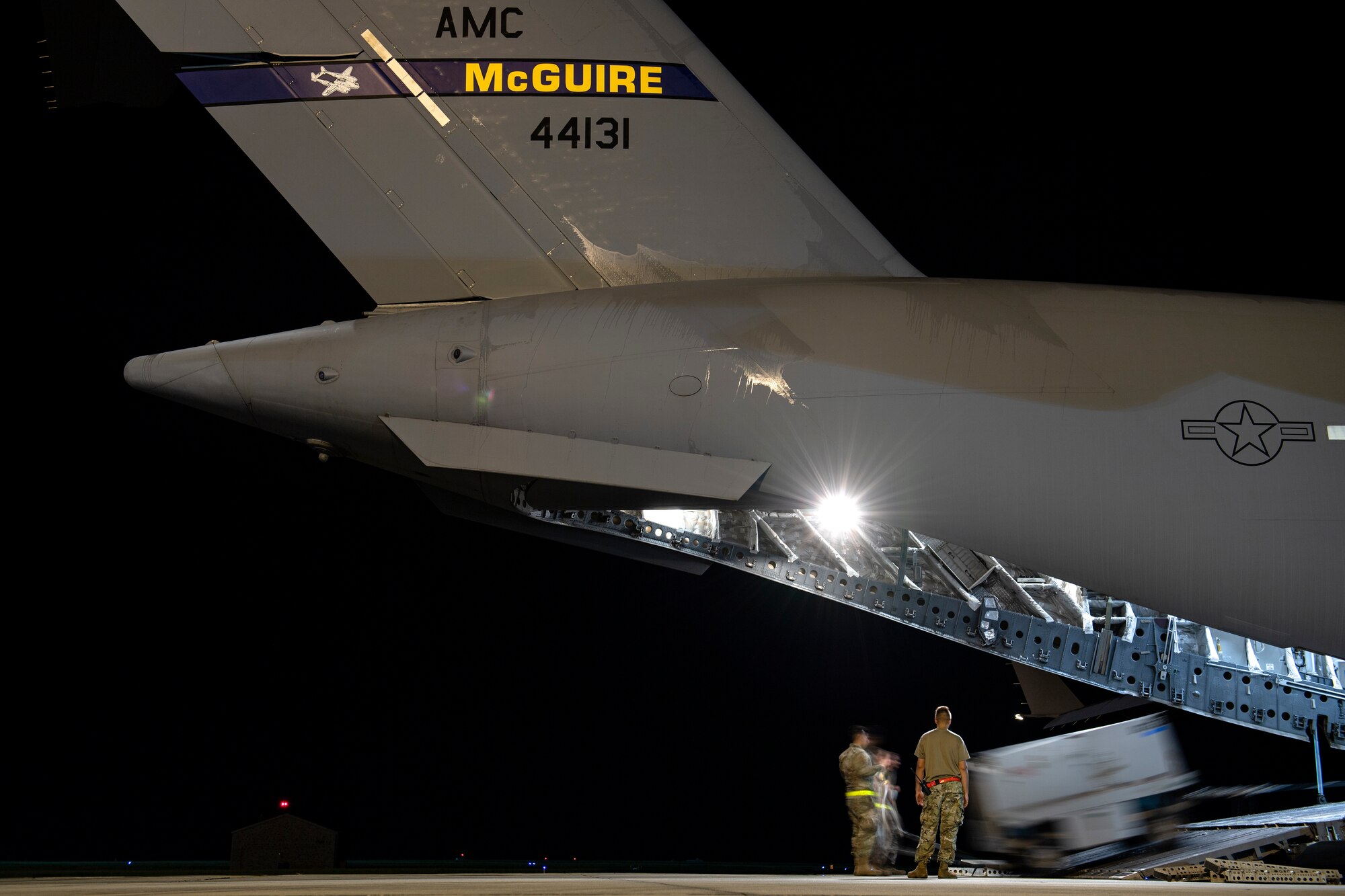 Photo of Airmen loading an aircraft