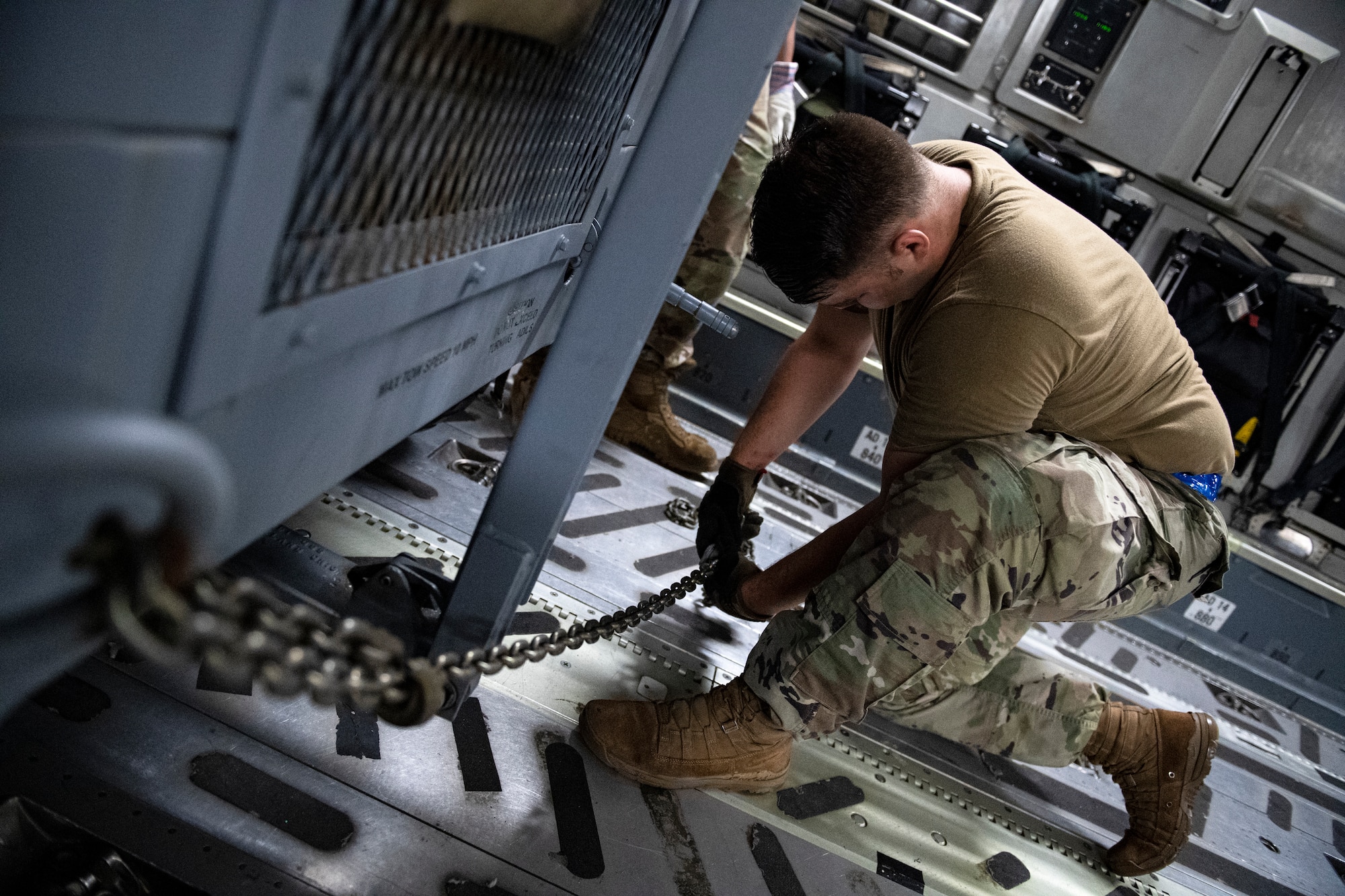 Photo of Airman loading equipment onto an aircraft