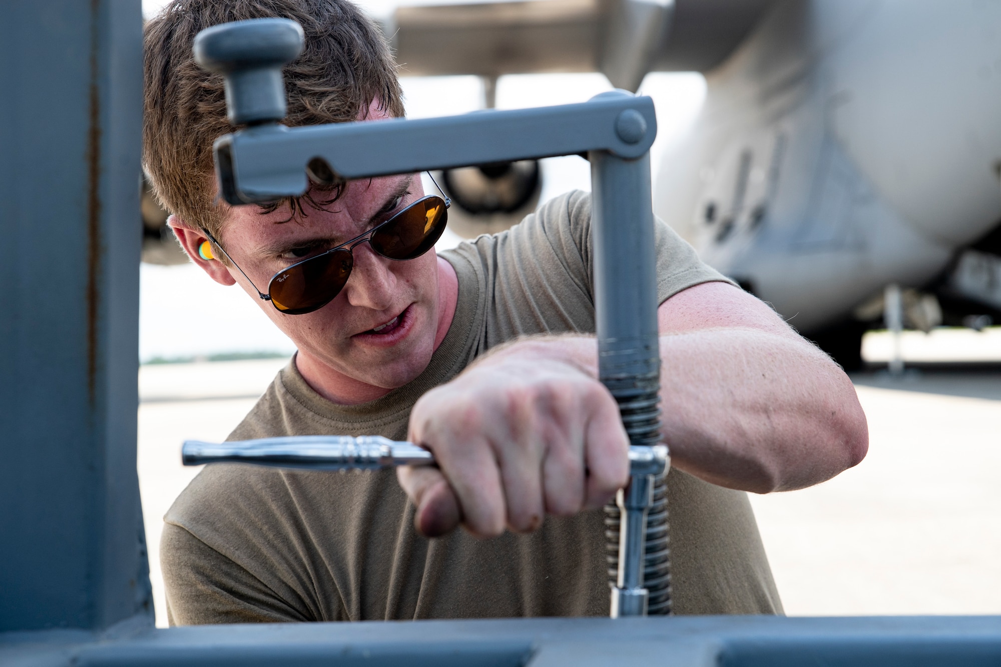Photo of an Airman using a wrench