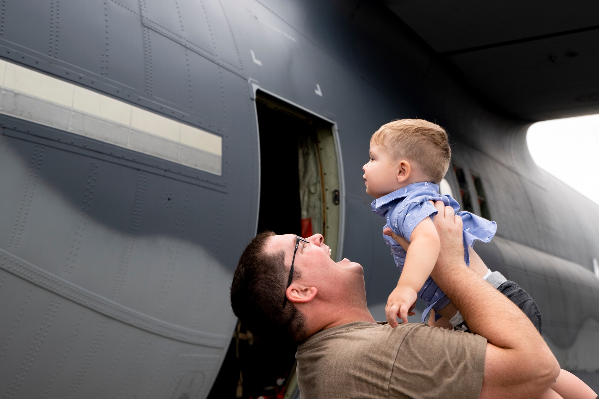 Photo of an Airman holding his child