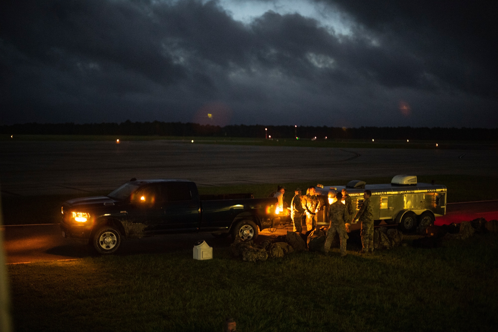 U.S. Air Force Airmen from the 822nd Base Defense Squadron K-9 unit wait near the flight line at Moody Air Force Base, Georgia, Aug. 29, 2021, prior to boarding an HC-130J Combat King II headed to Holloman Air Force Base, New Mexico. The K-9 unit is a force multiplier for the security presence of the 822nd BDS. (U.S. Air Force photo by Master Sgt. Daryl Knee)