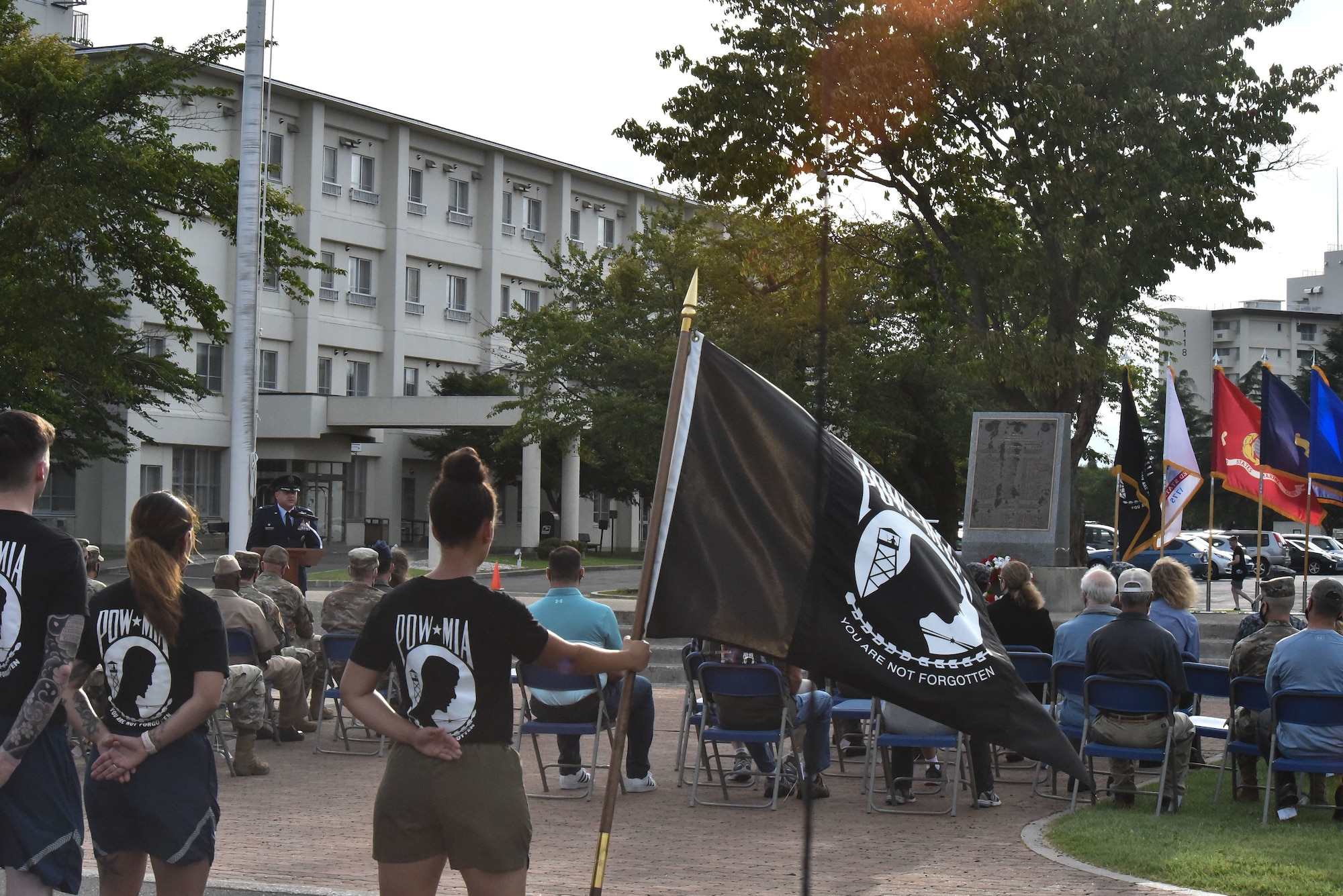 Members stand at parade rest while the guidon bearer holds the POW/MIA flag