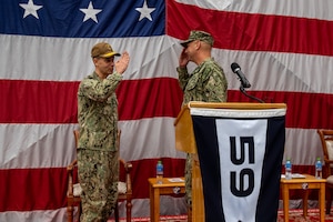 Vice Adm. Brad Cooper, left, commander of U.S. Naval Forces Central Command, U.S. 5th Fleet and Combined Maritime Forces, salutes Capt. Michael D. Brasseur, the first commodore of Task Force (TF 59) during a commissioning ceremony for TF 59 onboard Naval Support Activity Bahrain, Sept. 9. TF 59 is the first U.S. Navy task force of its kind, designed to rapidly integrate unmanned systems and artificial intelligence with maritime operations in the U.S. 5th Fleet area of operations.