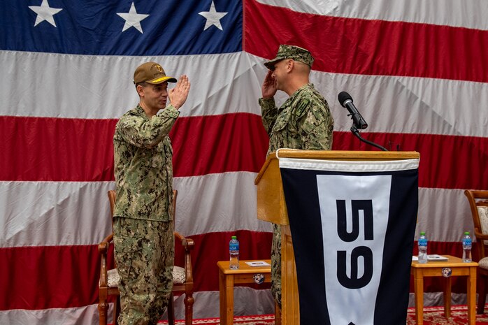 Vice Adm. Brad Cooper, left, commander of U.S. Naval Forces Central Command, U.S. 5th Fleet and Combined Maritime Forces, salutes Capt. Michael D. Brasseur, the first commodore of Task Force (TF 59) during a commissioning ceremony for TF 59 onboard Naval Support Activity Bahrain, Sept. 9. TF 59 is the first U.S. Navy task force of its kind, designed to rapidly integrate unmanned systems and artificial intelligence with maritime operations in the U.S. 5th Fleet area of operations.