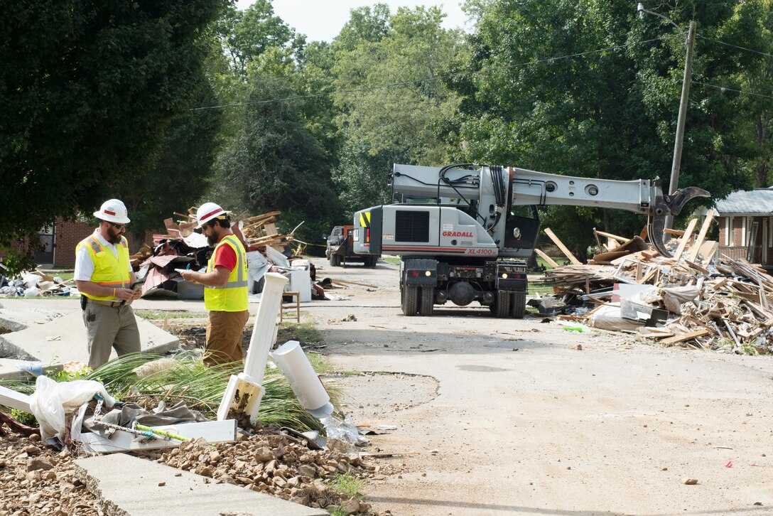 Robert Burick (Left), emergency management specialist with the Louisville District, and Mitchell Green, maintenance worker with the Kansas City District, both with the U.S. Army Corps of Engineers debris response team, observe debris operations Sept. 3, 2021 in Waverly, Tennessee. They are providing technical assistance following deadly flooding in Tennessee when up to 17 inches of rain fell in the region Aug. 21. (USACE Photo by Lee Roberts)