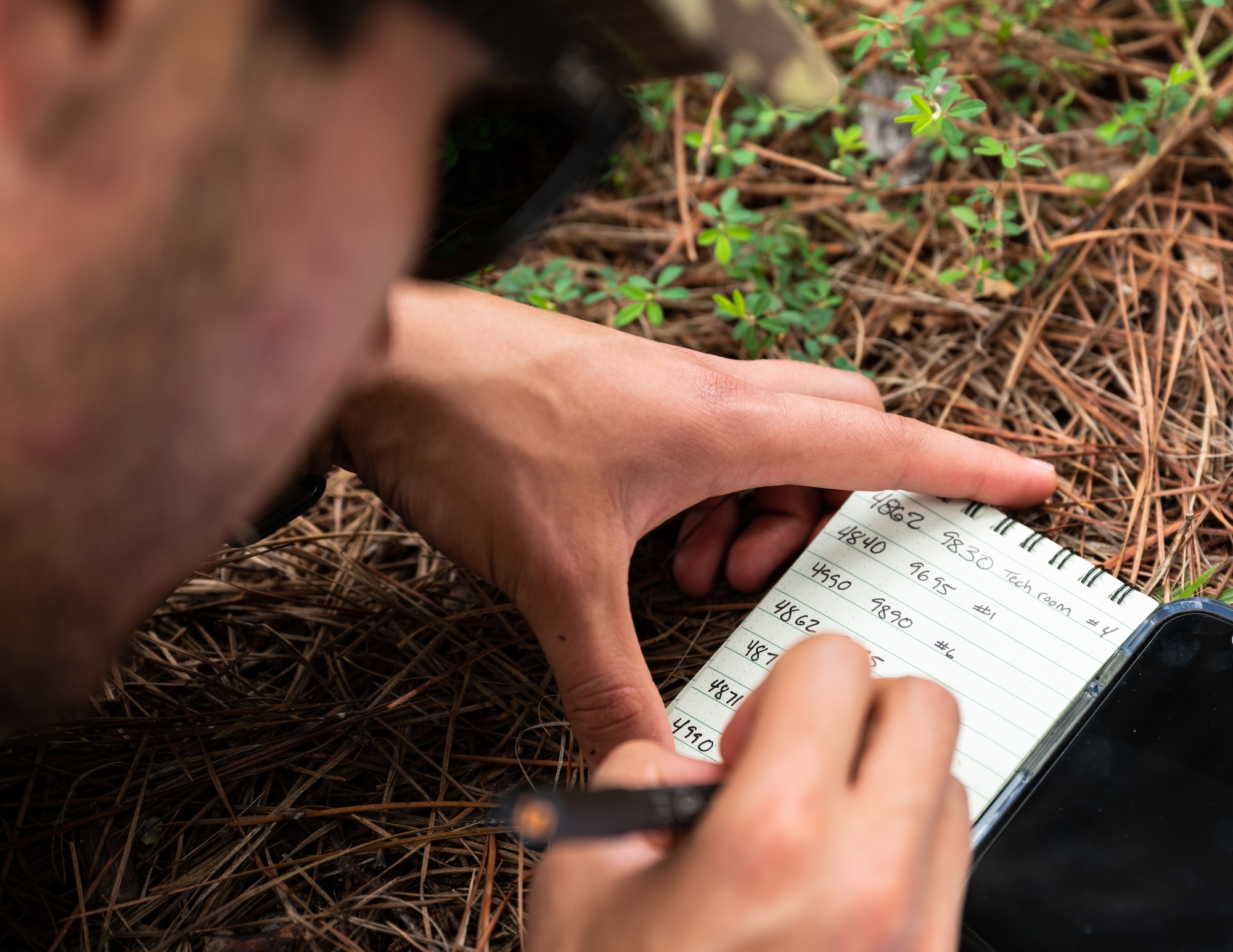 Senior Airman Eduardo Villareal, 2nd Security Forces Squadron installation access controller, marks down coordinates at Barksdale Air Force Base, Louisiana, Aug. 30, 2021.