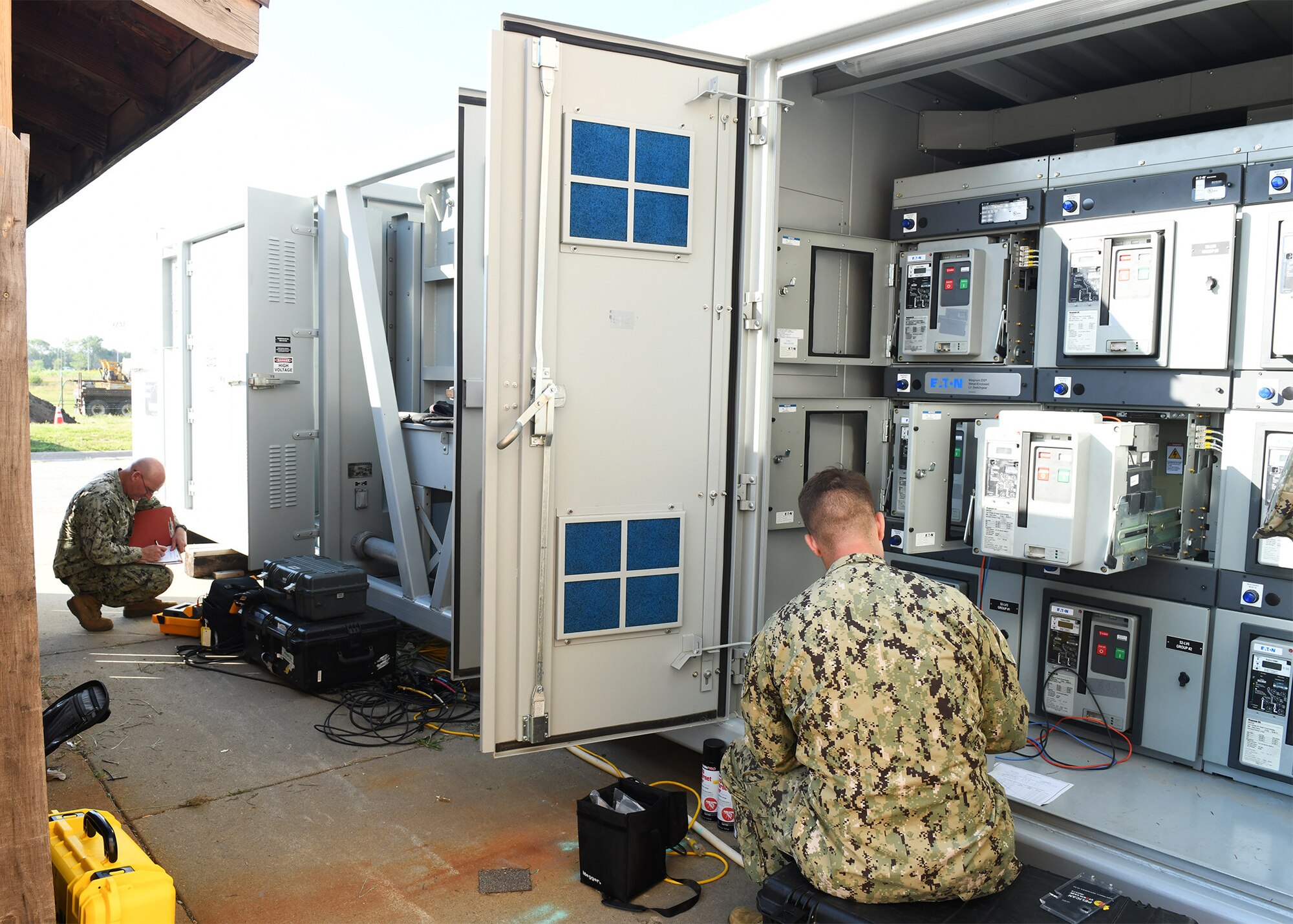 Two military members inspect 2500 kVa substation