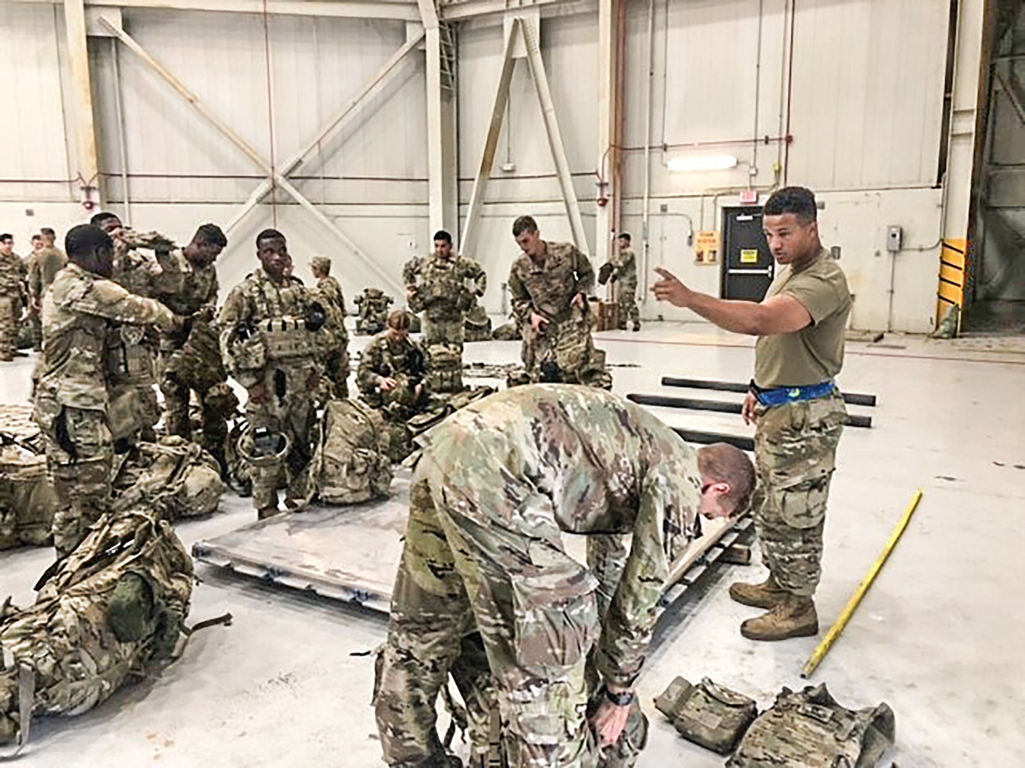 Senior Airman Jordan Scott, 87th Aerial Port Squadron, gives instructions to Soldiers on how to build a pallet. During their August 2021 annual tour at Joint Base Charleston, South Carolina, Reserve Citizen Airmen from the 87th APS were tasked with supporting the current mission in Afghanistan while working alongside their active duty counterpart hosts from the 437th Aerial Port Squadron.