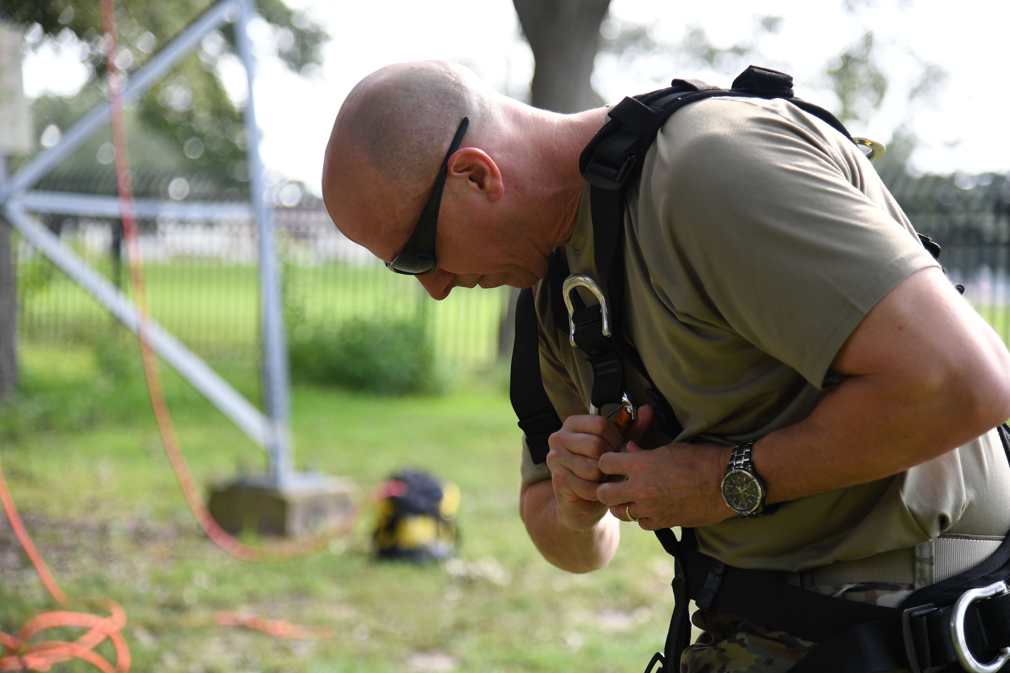 U.S. Air Force Col. William Hunter, 81st Training Wing commander, secures his equipment prior to participating in a tower climbing demonstration during an 85th Engineering Installation Squadron immersion tour behind Maltby Hall at Keesler Air Force Base, Mississippi, Sept. 1, 2021. The purpose of the tour was to become more familiar with the squadron's mission and its capabilities. (U.S. Air Force photo by Kemberly Groue)