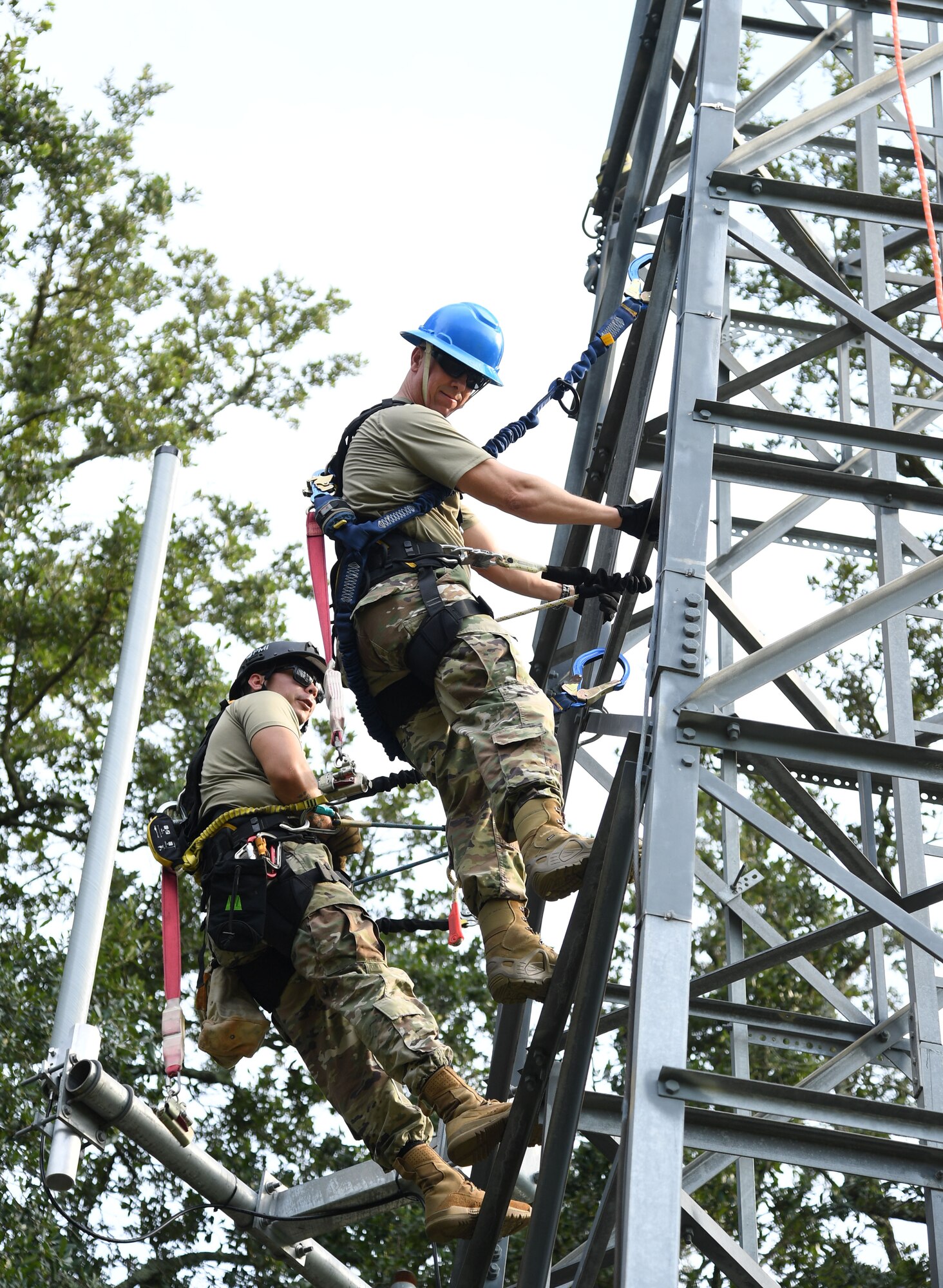 U.S. Air Force Col. William Hunter, 81st Training Wing commander, participates in a tower climbing demonstration with the assistance of Staff Sgt. Austin Johnson, 85th Engineering Installation Squadron cable and antenna systems technician, during an 85th EIS immersion tour behind Maltby Hall at Keesler Air Force Base, Mississippi, Sept. 1, 2021. The purpose of the tour was to become more familiar with the squadron's mission and its capabilities. (U.S. Air Force photo by Kemberly Groue)