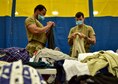 U.S. Air Force Airmen assigned to Task Force Liberty sort donated clothes for Afghans at Joint Base McGuire-Dix-Lakehurst, New Jersey, Aug. 28, 2021. The Department of Defense, through U.S. Northern Command, and in support of the Department of State and Department of Homeland Security, is providing transportation, temporary housing, medical screening, and general support for up to 50,000 Afghans at suitable facilities, in permanent or temporary structures, as quickly as possible. This initiative provides Afghan personnel essential support at secure locations outside Afghanistan. (U.S. Air Force photo by Staff Sgt. Jake Carter)