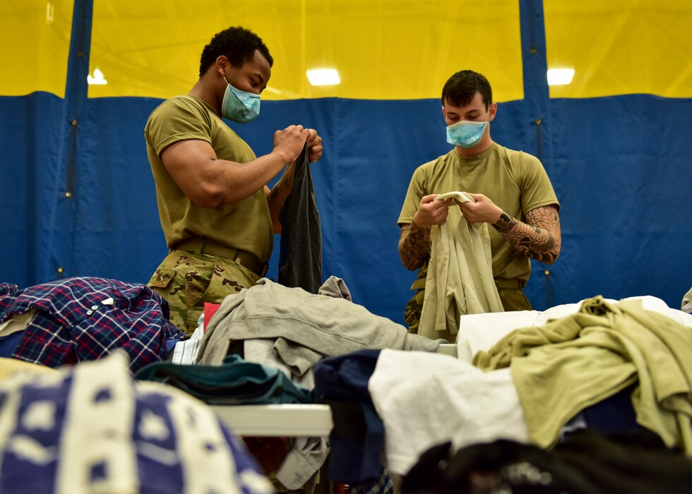 U.S. Air Force Airmen assigned to Task Force Liberty sort donated clothes for Afghans at Joint Base McGuire-Dix-Lakehurst, New Jersey, Aug. 28, 2021. The Department of Defense, through U.S. Northern Command, and in support of the Department of State and Department of Homeland Security, is providing transportation, temporary housing, medical screening, and general support for up to 50,000 Afghans at suitable facilities, in permanent or temporary structures, as quickly as possible. This initiative provides Afghan personnel essential support at secure locations outside Afghanistan. (U.S. Air Force photo by Staff Sgt. Jake Carter)