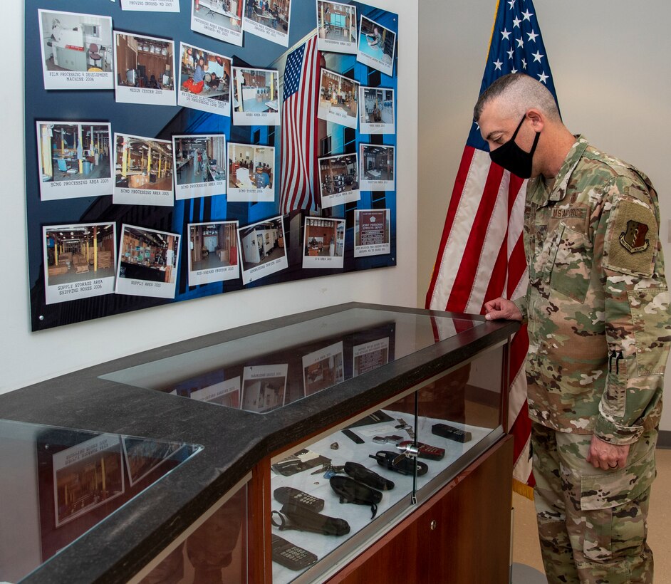 Master Sgt. Mark Weber, Armed Forces Medical Examiner System senior enlisted advisor, looks at cell phones recovered after 9/11 at the Joint Personal Effects Depot on Dover Air Force Base, Delaware, Sept. 8, 2021. JPED was established the morning of Sept. 11, 2001, to recover, inventory, photograph, clean, service and return the personal effects of all the Pentagon fatalities. What remains at Dover AFB are items that were not claimed. (U.S. Air Force photo by Tech. Sgt. Nicole Leidholm)
