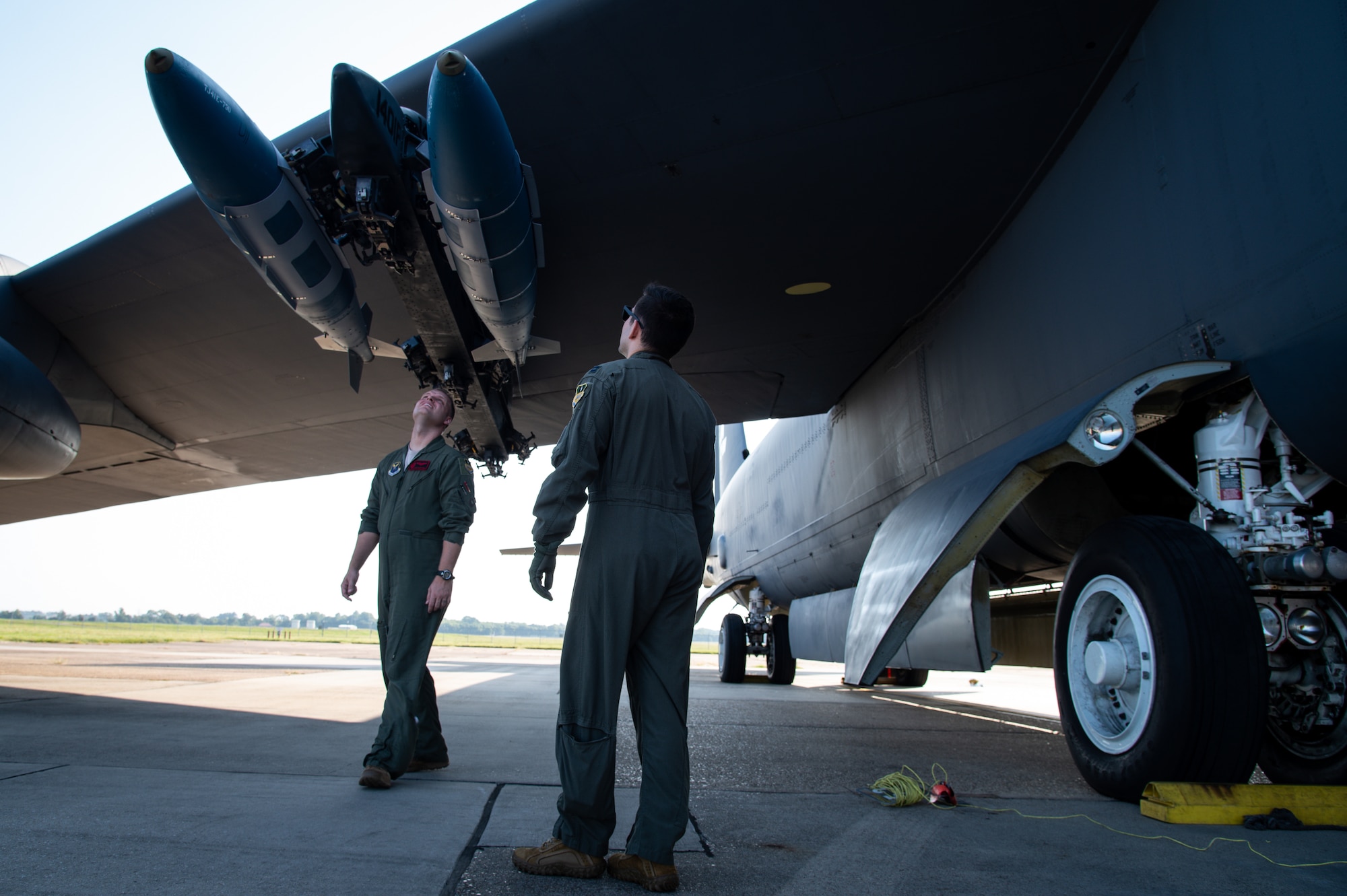 Maj. James Bell, 96th Bomb Squadron aircraft commander, and Capt. Phillip Hightower, 96th BS co-pilot, inspect conventional munitions before takeoff at Barksdale Air Force Base, Louisiana, Aug. 25, 2021. Inspecting munitions is part of an important pre-flight checklist vital to ensuring flight safety and proper weapon functionality. (U.S. Air Force photo by Airman 1st Class Chase Sullivan)