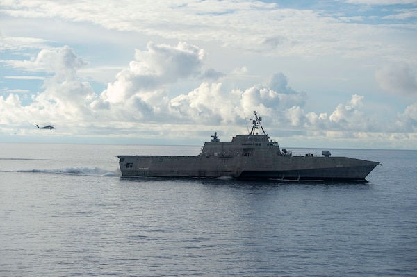 SOUTH CHINA SEA (Sept. 7, 2021) An MH-60S Sea Hawk, assigned to the “Black Knights” of Helicopter Sea Combat Squadron (HSC) 4, hovers near Independence-variant Littoral Combat Ship USS Tulsa (LCS 16), while the LCS sails alongside Nimitz-class aircraft carrier USS Carl Vinson (CVN 70), Sept. 7, 2021.