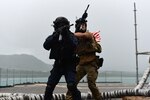 A Japan Maritime Self-Defense Force sailor and a U.S. Naval Special Warfare operator conduct a simulated visit, board, search, and seizure aboard USS Frank Cable (AS-40) as part of MALABAR 2021. MALABAR 2021 is an example of the enduring partnership between Australian, Indian, Japanese and American maritime forces, who routinely operate together in the Indo-Pacific, fostering a cooperative approach toward regional security and stability. Naval Special Warfare is the nation’s premiere maritime special operations force and is uniquely positioned to extend the Fleet’s reach and deliver all-domain options for naval and joint force commanders.