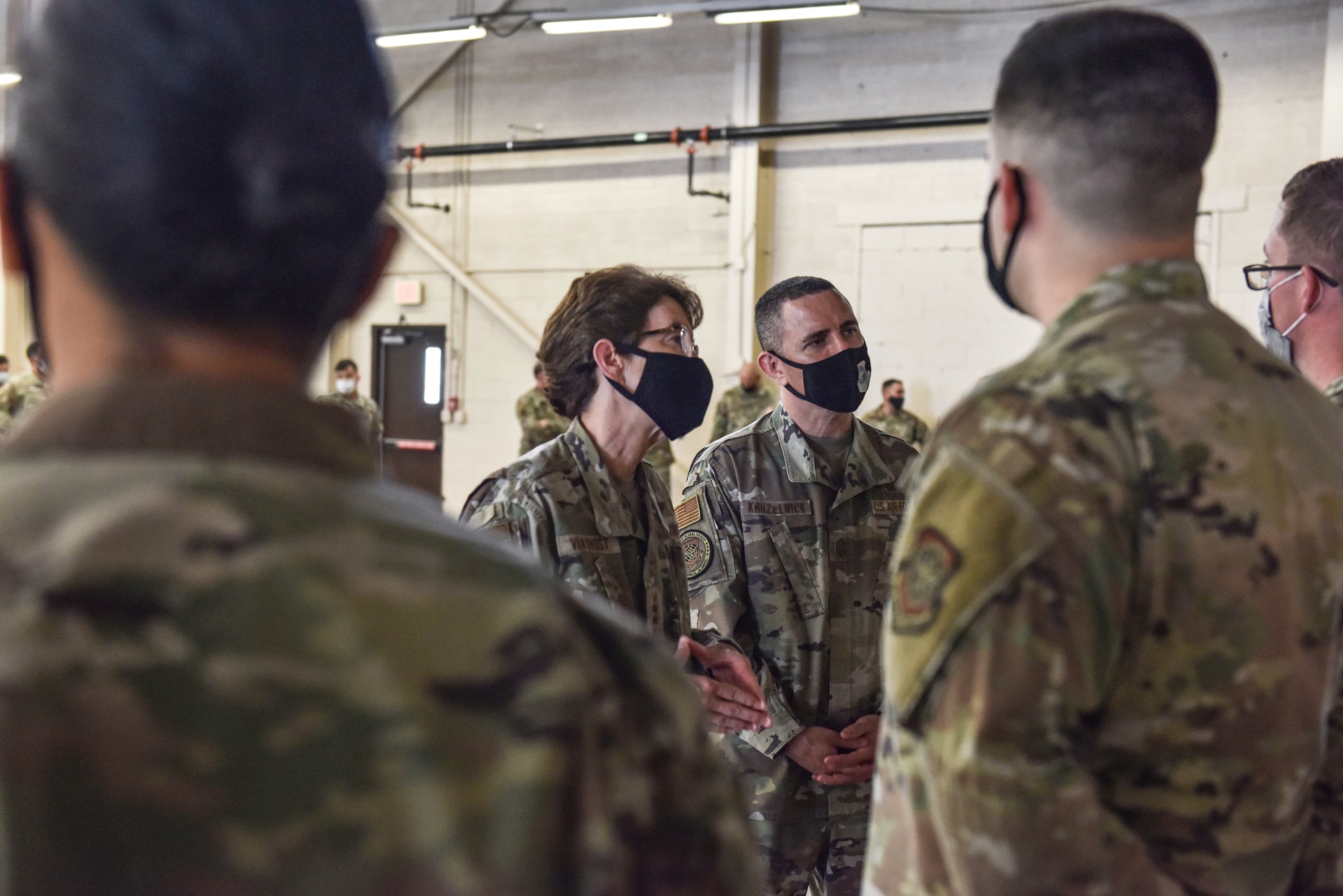 U.S. Air Force Gen. Jacqueline D. Van Ovost, Air Mobility Command commander, and Chief Master Sgt. Brian Kruzelnick, AMC command chief, listen to experiences of Airmen who helped provide support to Liberty Village at Joint Base McGuire-Dix-Lakehurst, N.J., Sept. 8, 2021. AMC leadership visited the 87th Air Base Wing to recognize personnel who were instrumental in setting up Liberty Village on the installation. Liberty Village is managed by Joint Task Force-Liberty and provides housing and care for vulnerable Afghans going through the immigration process with the Department of Home Affairs. (U.S. Air Force Photo by Staff Sergeant Shay Stuart)