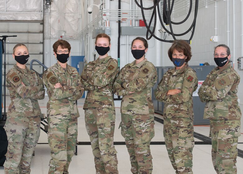 Gen. Jacqueline Van Ovost, Air Mobility Command commander, and Chief Master Sgt. Brian Kruzelnick, command chief master sergeant for Air Mobility Command, met with local New Hampshire state and National Guard leadership and recognized Airmen who showed outstanding support of the AMC mission. Several women from the base stand with Van Ovost inside the new KC-46 Hangar.