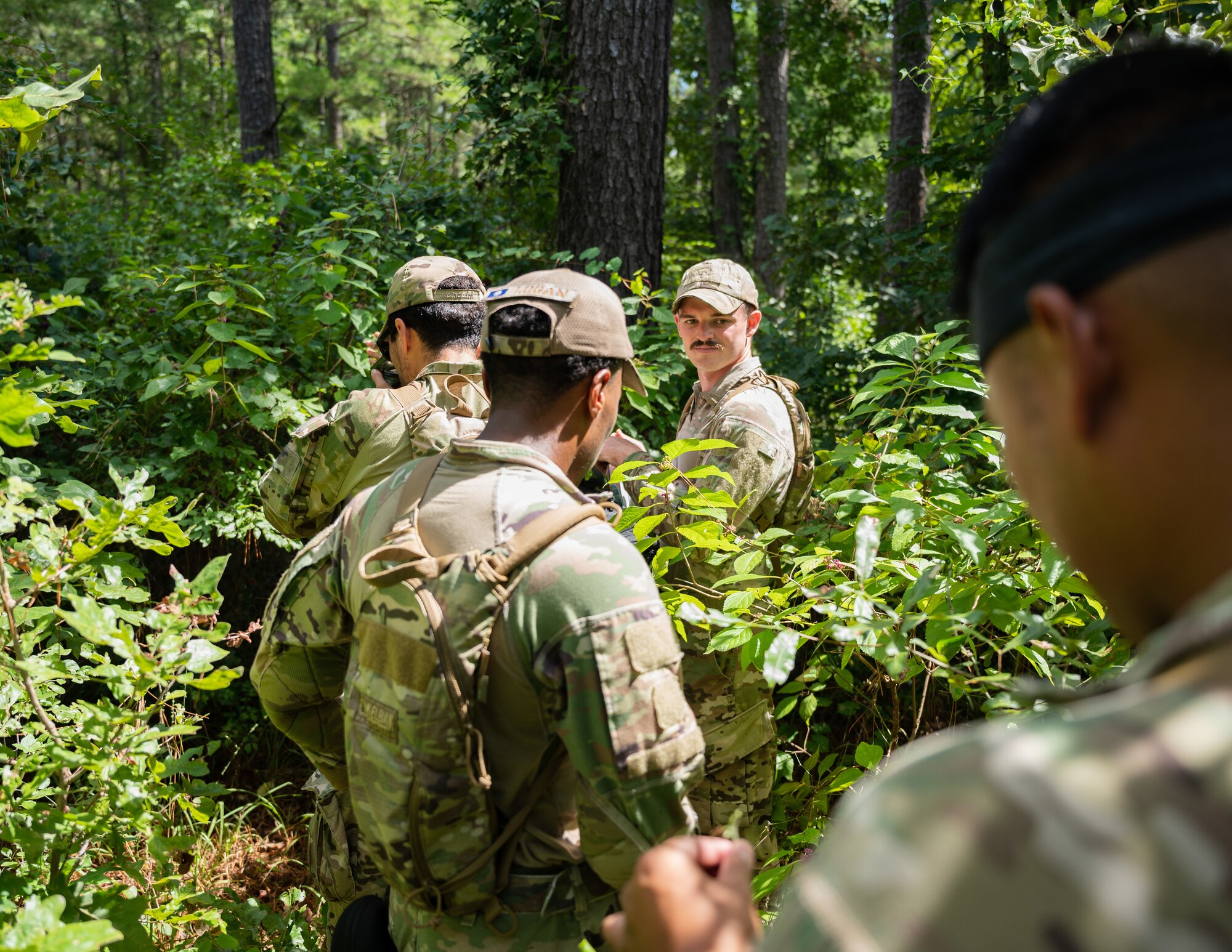 Airmen from the 2nd Security Forces Squadron navigate the east reservation wilderness at Barksdale Air Force Base, Louisiana, Aug. 30, 2021.