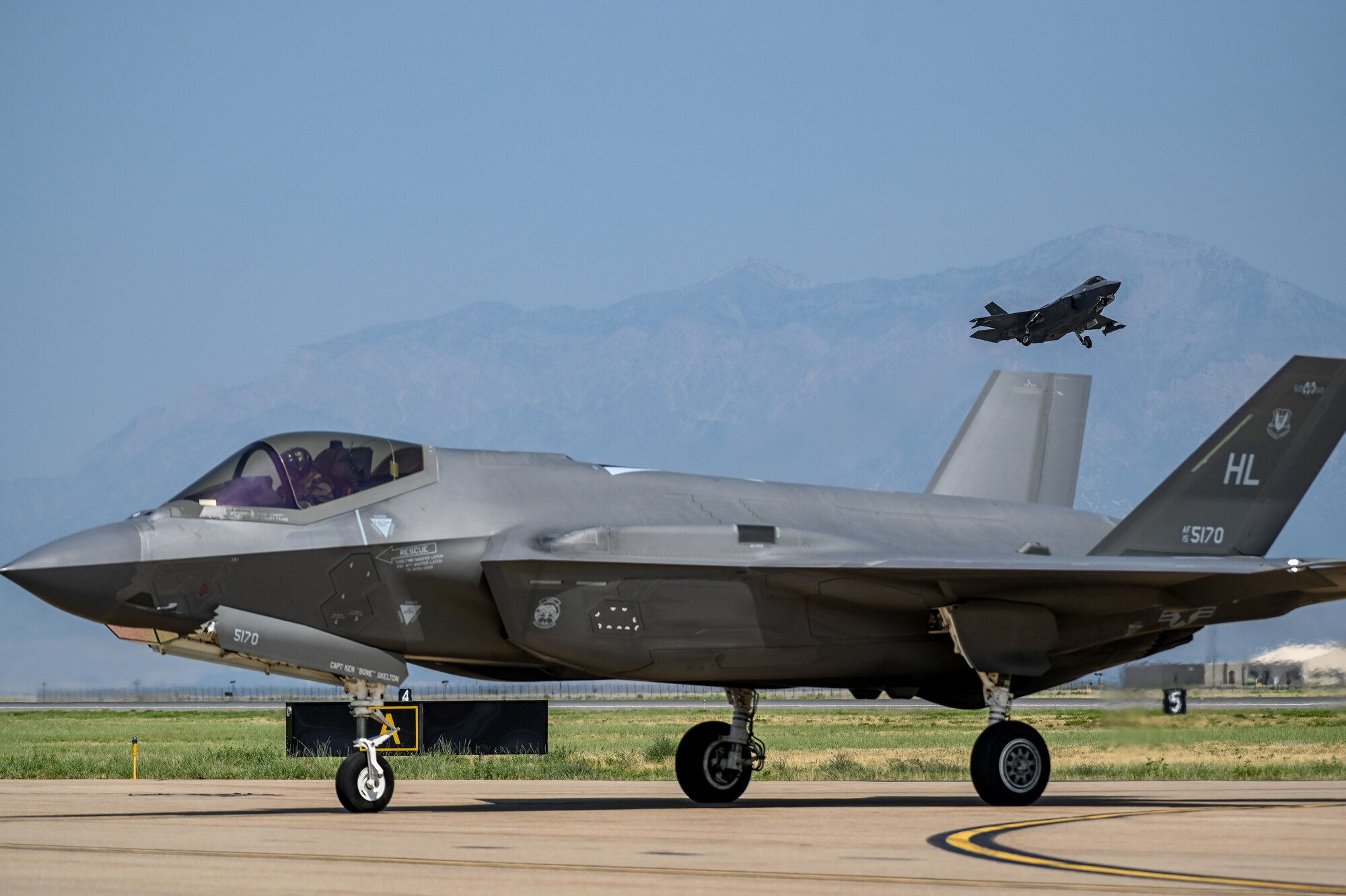 An F-35A Lightning II assigned to 388th Fighter Wing at Hill lands as another F-35A from the 63rd Fighter Squadron at Luke Air Force Base takes off Aug. 25, 2021, at Hill Air Force Base, Utah. The 63rd FS was participating in a Weapons System Evaluation Programs, known as Combat Hammer and Combat Archer, which tests and validates the performance of crews, pilots, and their technology while deploying air-to-air and air-to-ground munitions. (U.S. Air Force photo by Cynthia Griggs)