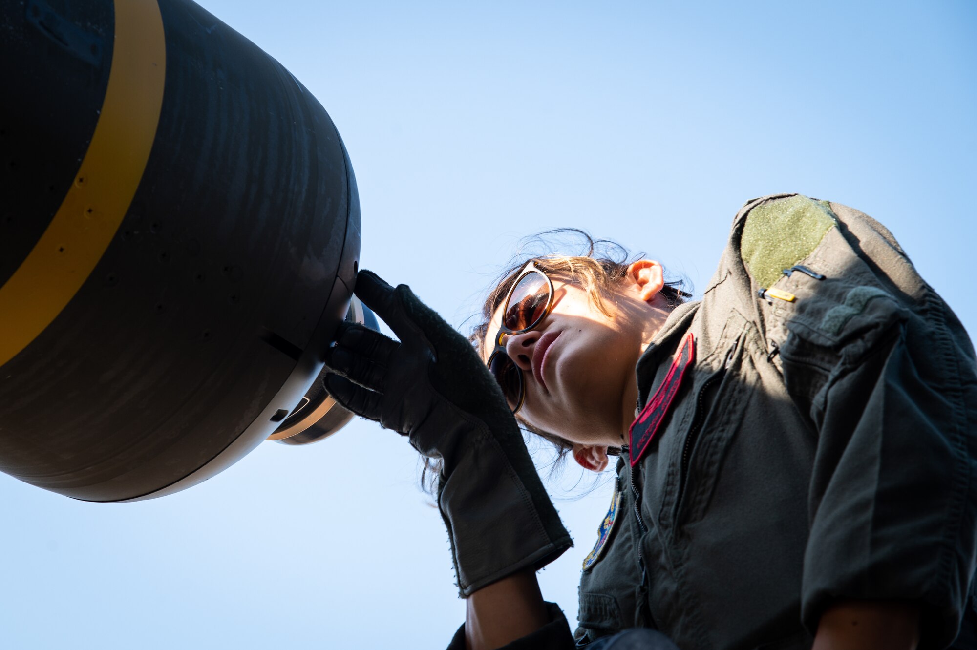 First Lt. Victoria Gurrola, 96th Bomb Squadron weapon systems officer, inspects a CBU-105 conventional munition before takeoff at Barksdale Air Force Base, Louisiana, Aug. 25, 2021. CBU-105s are multi-targeting bombs capable of destroying numerous armored targets in a single drop. (U.S. Air Force photo by Airman 1st Class Chase Sullivan)