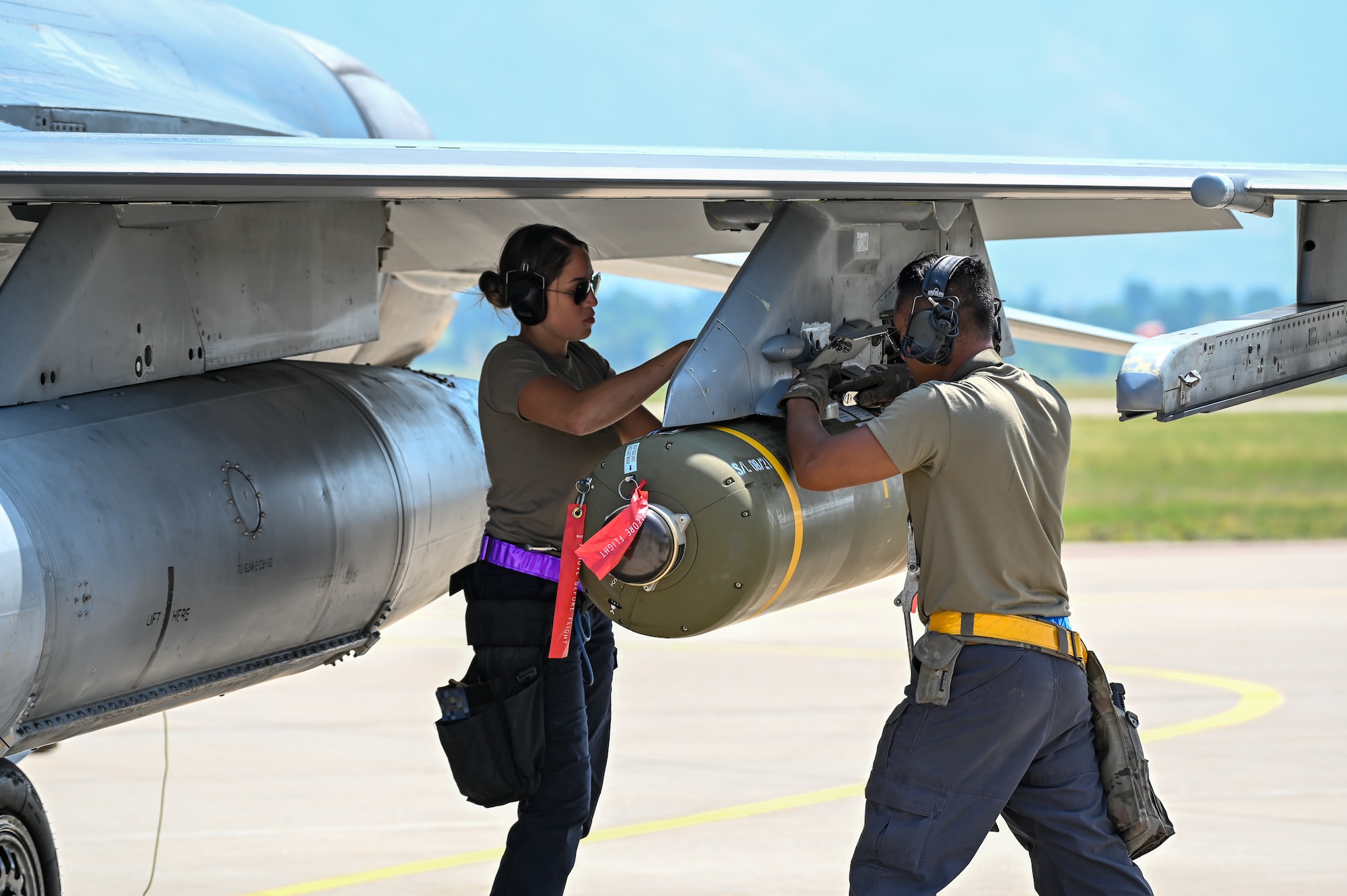 Airmen assigned to the 31st Fighter Wing from Aviano Air Base, Italy, ready weapons on an F-16 Fighting Falcon Aug. 25, 2021, at Hill Air Force Base, Utah. The wing was participating in a Weapons System Evaluation Programs, known as Combat Hammer and Combat Archer, which tests and validates the performance of crews, pilots, and their technology while deploying air-to-air and air-to-ground munitions. (U.S. Air Force photo by Cynthia Griggs)