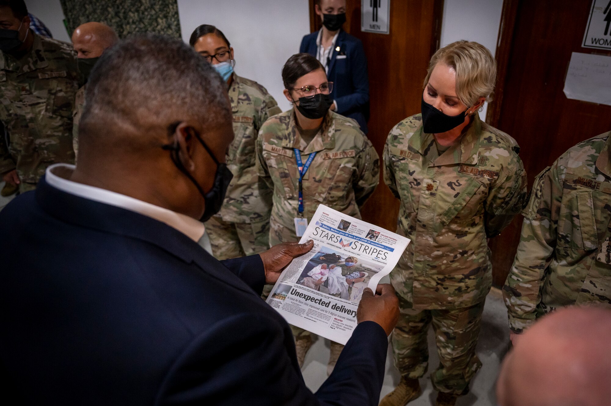 Secretary of Defense Lloyd J. Austin III looks at a newspaper highlighting service members who supported Afghanistan evacuation operations Sept. 07, 2021, at Al Udeid Air Base, Qatar.