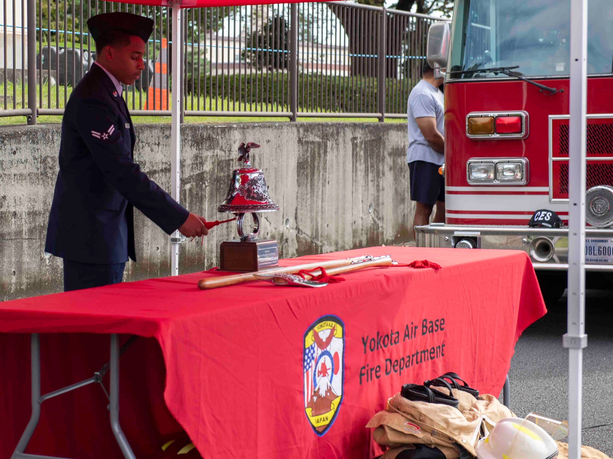 Airman 1st Class Preston Taylor, 374th Civil Engineer Squadron firefighter, rings a bell prior to the 10th annual Yokota Fire Emergency 9/11 Tower Run at Yokota Air Base, Japan, Sept. 10, 2021.