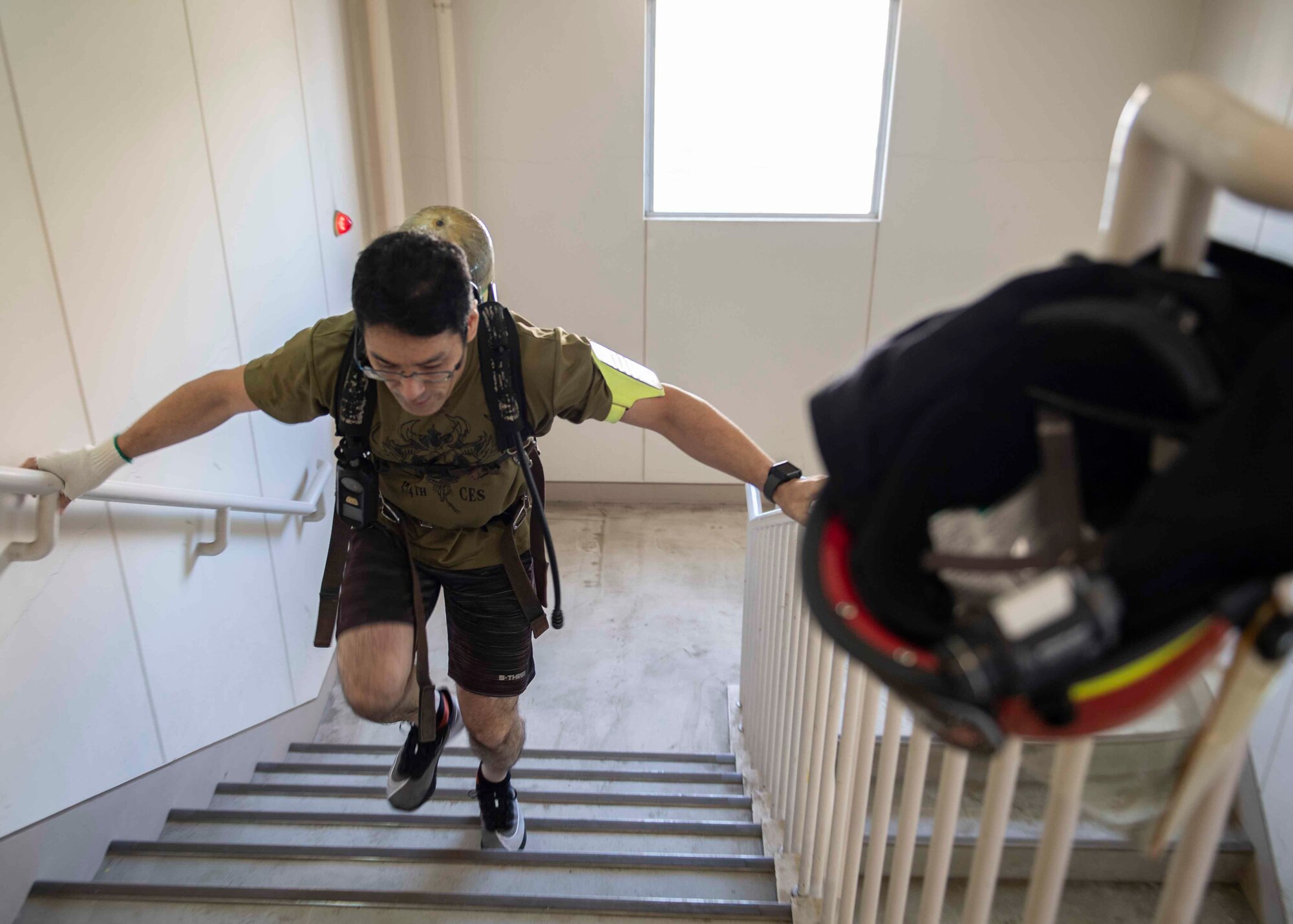 Tetso Hayashi, Japan Air Self Defense Force firefighter, runs up a flight of stairs during the 10th annual Yokota Fire Emergency 9/11 Tower Run at Yokota Air Base, Japan, Sept. 10, 2021.