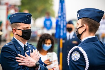 Col. Richard Martin, left, 423rd Air Base Group commander, receives a folded flag during a 9/11remembrance ceremony at RAF Alconbury, England, Sept. 9, 2021.  Airmen from the 501st Combat Support Wing, cadets from the Alconbury Middle Highschool JROTC and guests came together to pay homage to those who lost their lives during the Sept. 11, 2001, attacks. (U.S. Air Force photo by Senior Airman Eugene Oliver)