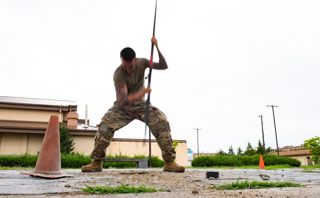 U.S. Air Force Staff Sgt. William Criswell, 8th Civil Engineer Squadron noncommissioned officer in charge of the lock shop, breaks down dirt for the foundation of the Wolf Pack Legacy Garden at Kunsan Air Base, Republic of Korea, Aug 28, 2021. Volunteers from across Kunsan Air Base dedicated hours of woodworking, gardening, painting and more to ensure the pergola and garden were built and dedicated to veterans by Sept 8, 2021.. (U.S. Air Force photo by Staff Sgt. Gabrielle Spalding)