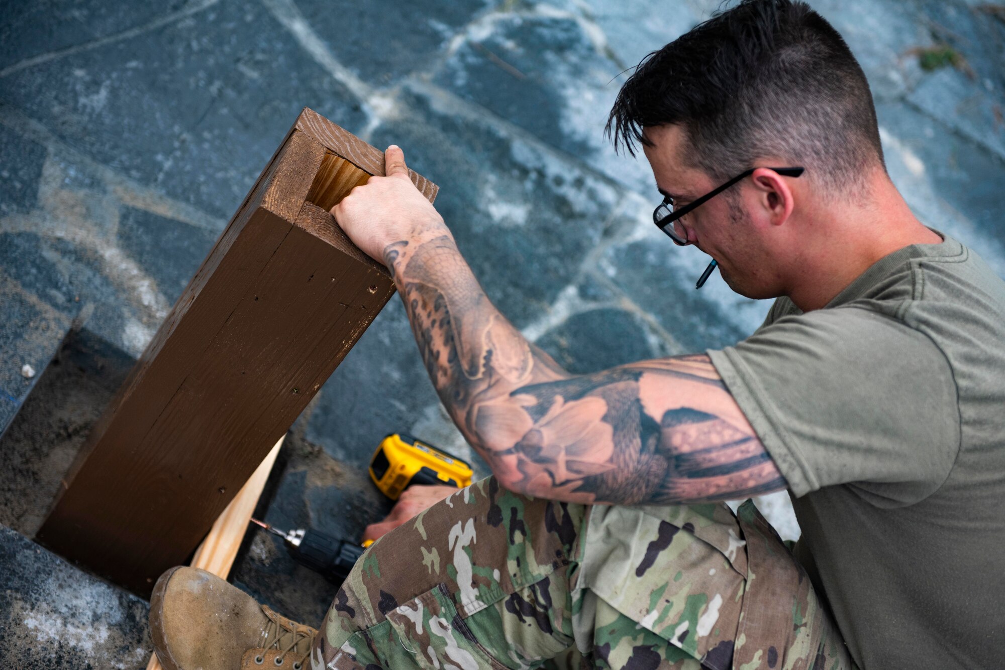 U.S. Air Force Staff Sgt. William Criswell, 8th Civil Engineer Squadron noncommissioned officer in charge of the lock shop, stabilizes the foundation of the Wolf Pack Legacy Garden at Kunsan Air Base, Republic of Korea, Aug 28, 2021. Volunteers from across Kunsan Air Base dedicated hours of woodworking, gardening, painting and more to ensure the pergola and garden were built and dedicated to veterans by Sept 8, 2021. (U.S. Air Force photo by Staff Sgt. Gabrielle Spalding)