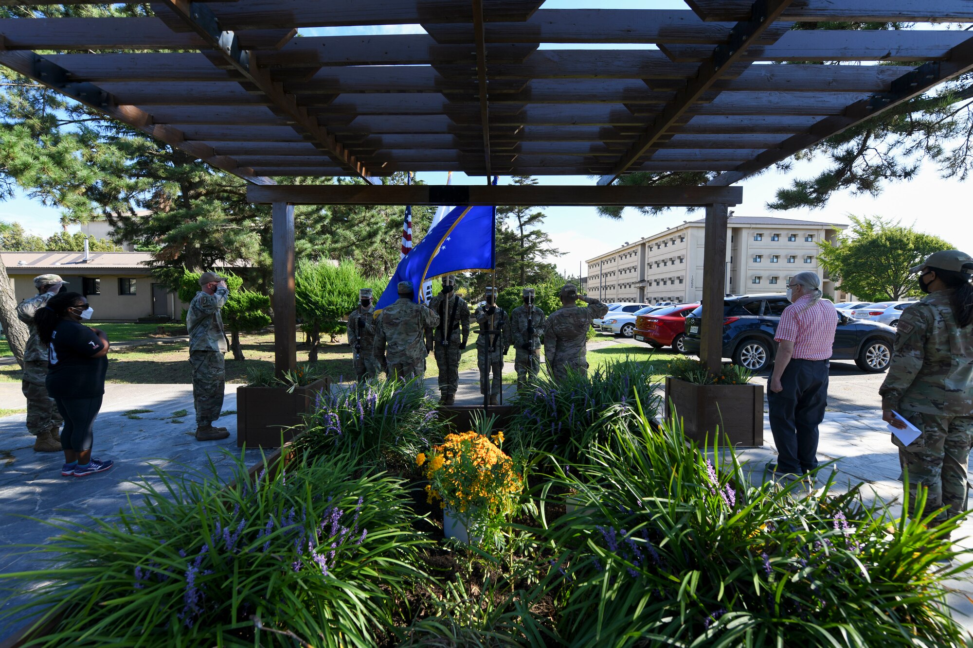 The Kunsan Air Base Honor Guard presents the colors during the Wolf Pack Legacy Garden dedication ceremony at Kunsan Air Base, Republic of Korea, Aug 28, 2021. Volunteers from across Kunsan Air Base dedicated hours of woodworking, gardening, painting and more to ensure the pergola and garden were built and dedicated to veterans by Sept 8, 2021. (U.S. Air Force photo by Staff Sgt. Jesenia Landaverde)