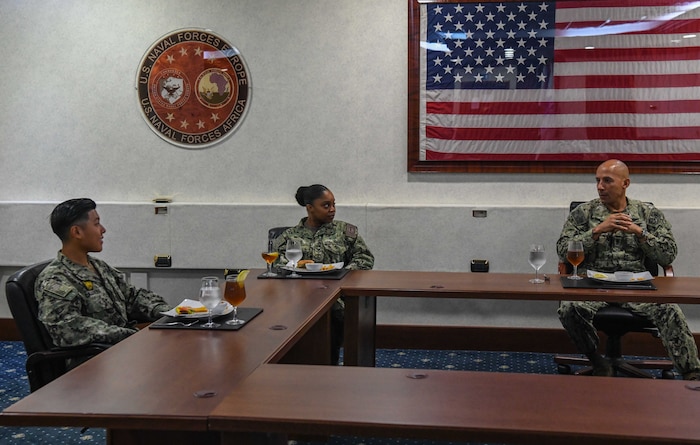 (Aug. 11, 2021) U.S. Naval Forces Europe and Africa Fleet Master Chief Derrick Walters, right, speaks with Yeoman 1st Class Yanique Mott, center, and Master-at-Arms 2nd Class Abbie Cabrera during a “Breaking Bread with the Best”  luncheon for top performing Sailors in the European and African theaters, Aug. 11, 2021. U.S. Naval Forces Europe and Africa, headquartered in Naples, Italy, conducts the full spectrum of joint and naval operations, often in concert with allied and interagency partners, in order to advance U.S. national security interests and stability in Europe and Africa.