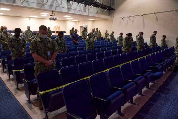 NAVAL STATION NORFOLK (Sept. 9, 2021) Personnel assigned to Naval Surface Force Atlantic pray during a 9/11 20th anniversary remembrance ceremony, Sept. 9. The ceremony honored those affected by the deadliest series of terrorist attacks since Pearl Harbor, affirming the United States Navy’s ongoing commitment to deter future terrorist attacks and to never forget our American legacy of tenacity and resiliency.  (U.S. Navy photo by Mass Communication Specialist 1st Class Jacob Milham) (This photo has been altered for security purposes by blurring out identification badges.)